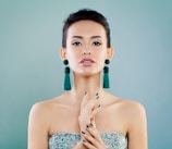 A woman in a strapless dress holding her hands together