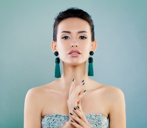 A woman in a strapless dress holding her hands together