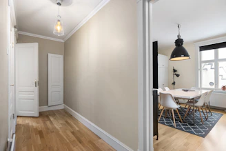 A room with a wooden floor and white walls