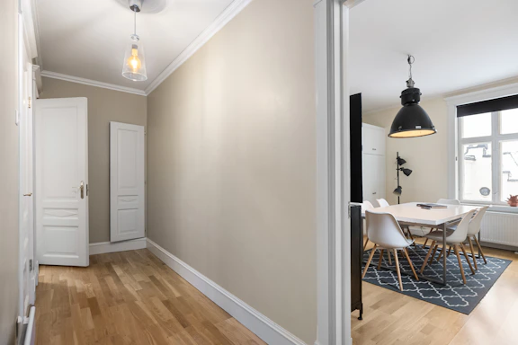 A room with a wooden floor and white walls
