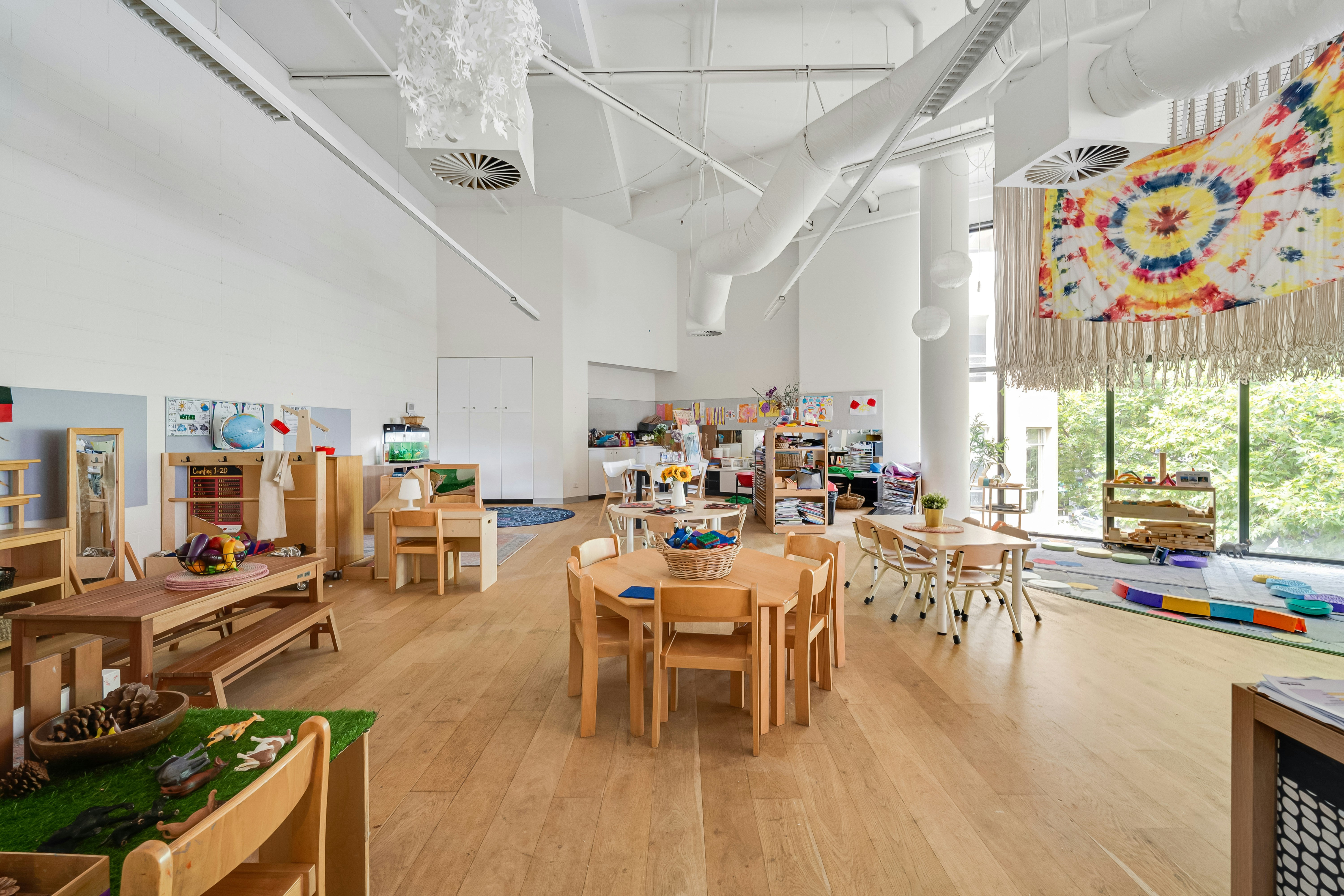 Wooden tables and chairs in natural learning space