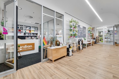 A store with a wooden floor and white walls