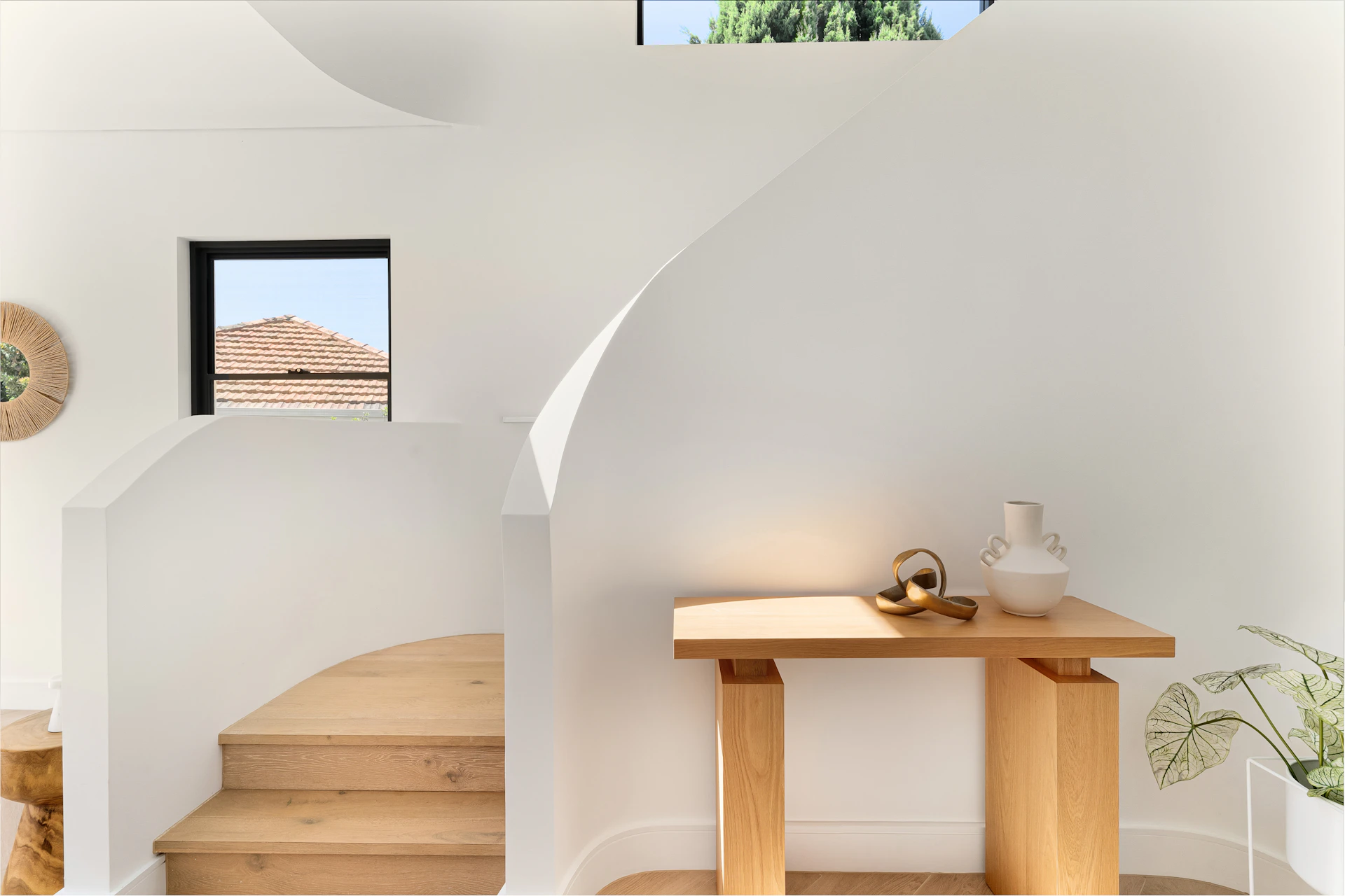 A living room with a table and stairs