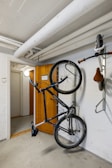 A bike hanging on a wall in a garage
