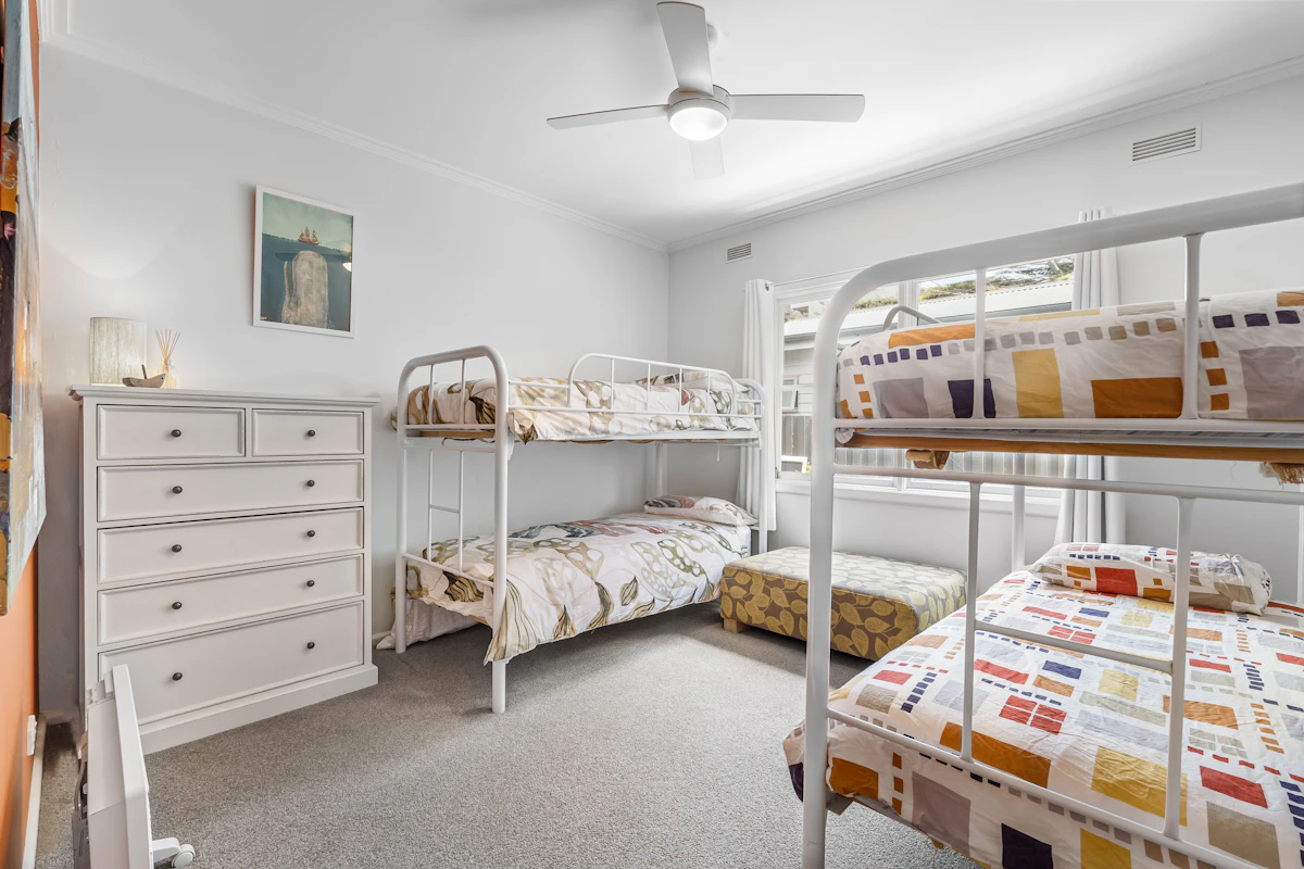 Eight-bed dorm with rows of wooden bunks