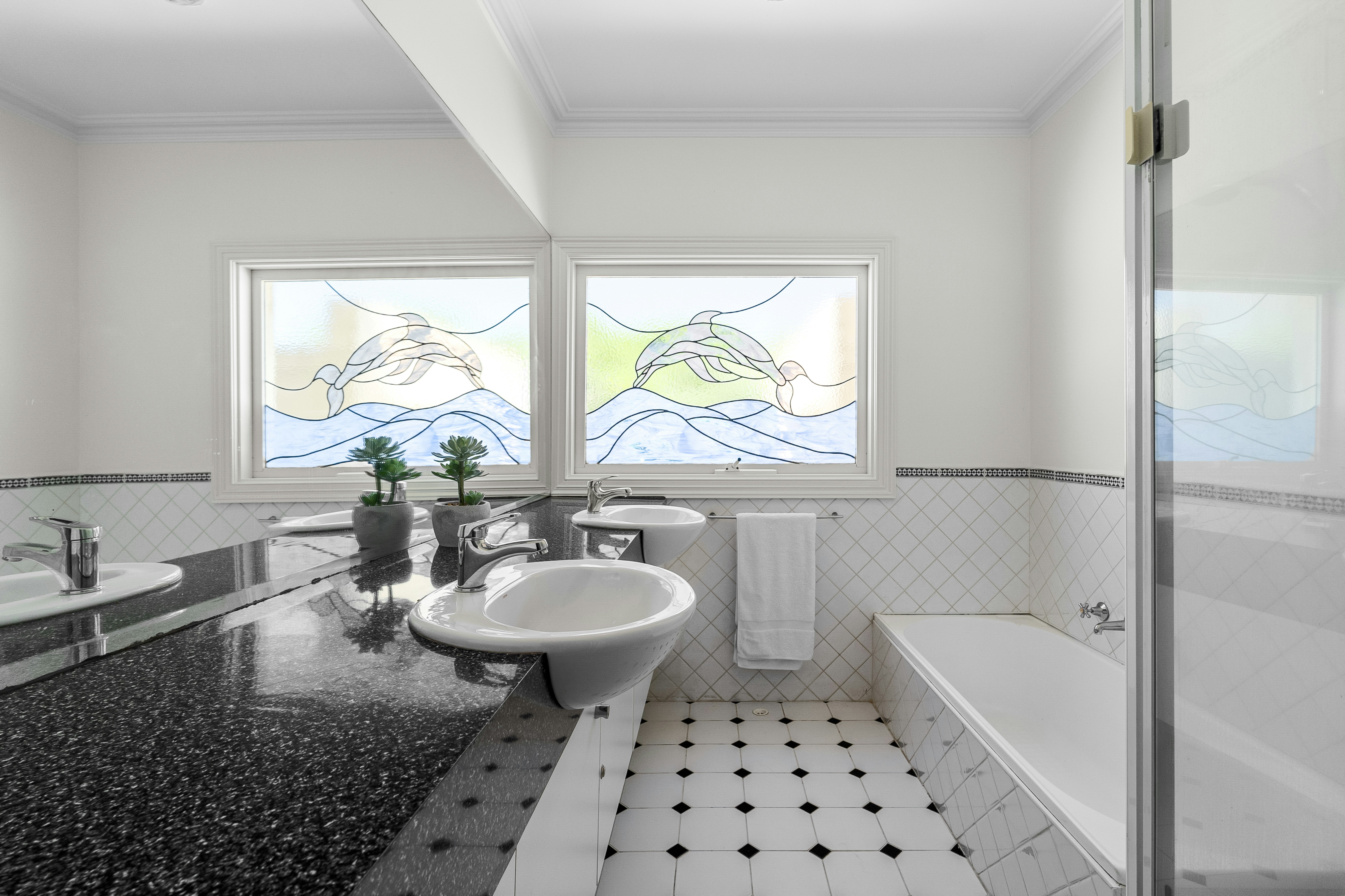 A bathroom with a sink, bathtub, and shower