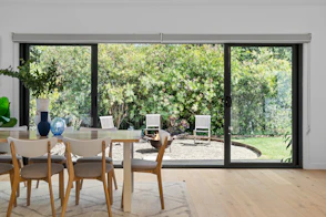 A dining room with a table and chairs