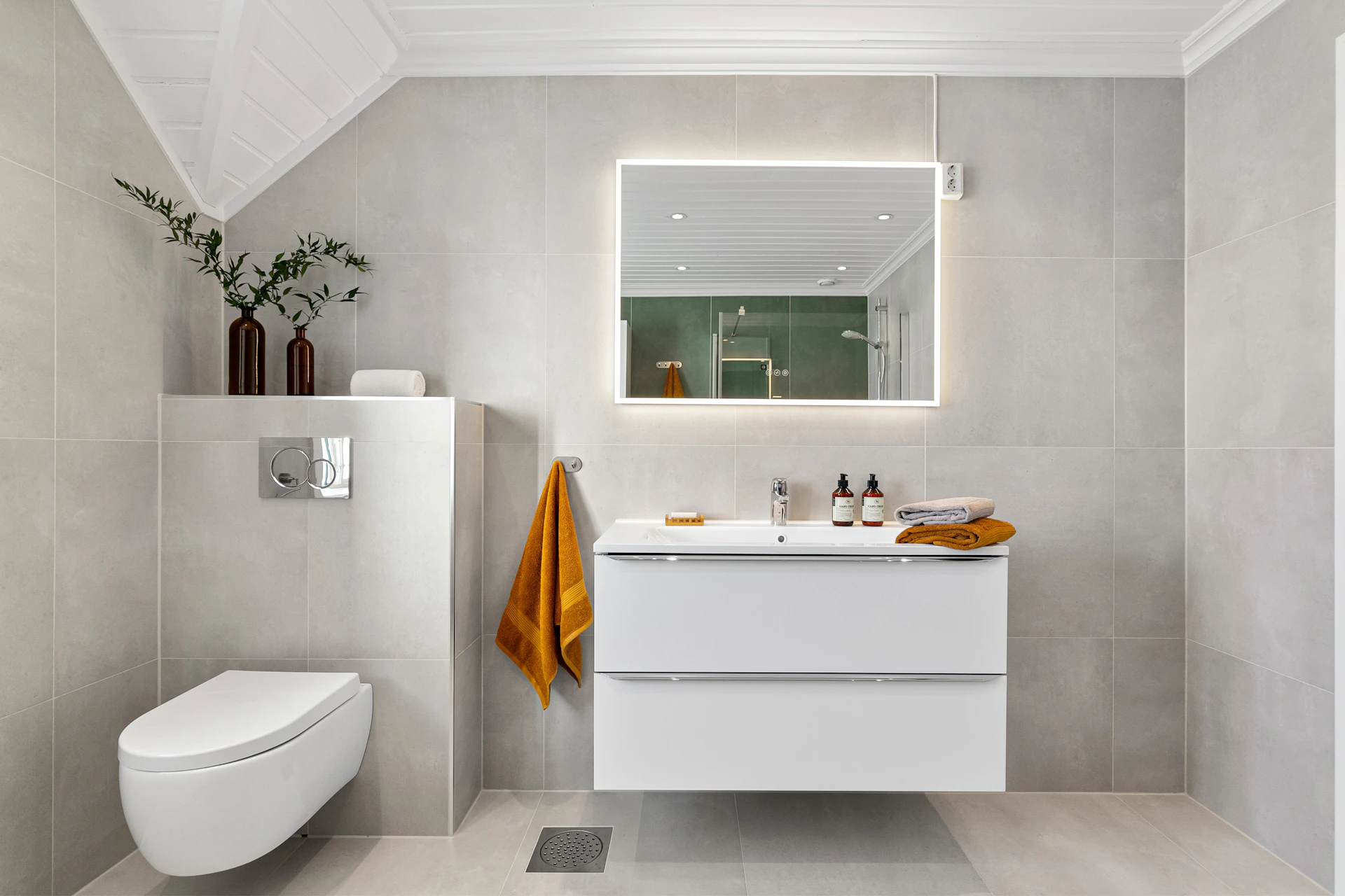 A bathroom with a toilet, sink and mirror