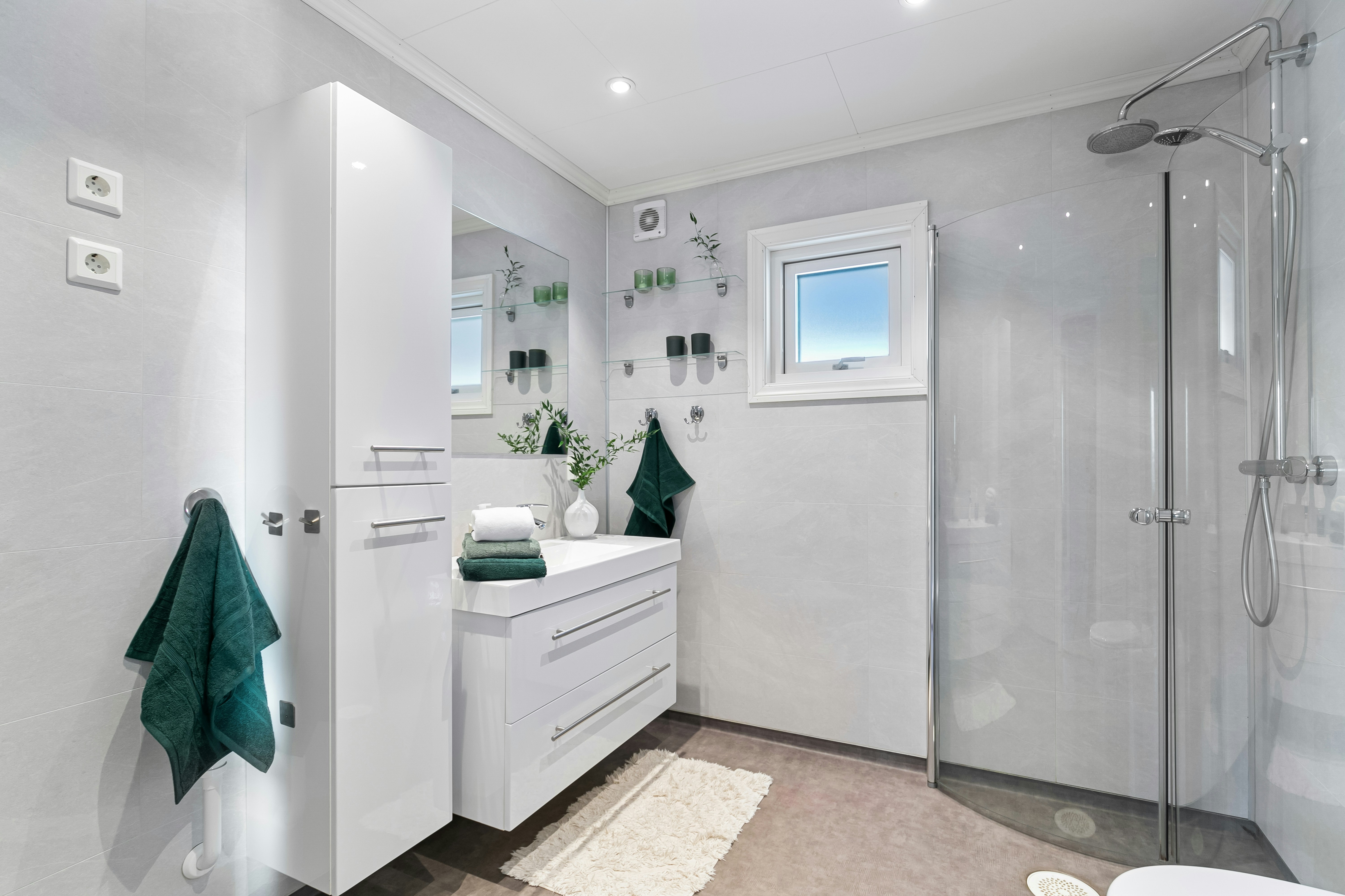 A bathroom with a shower, sink, and toilet