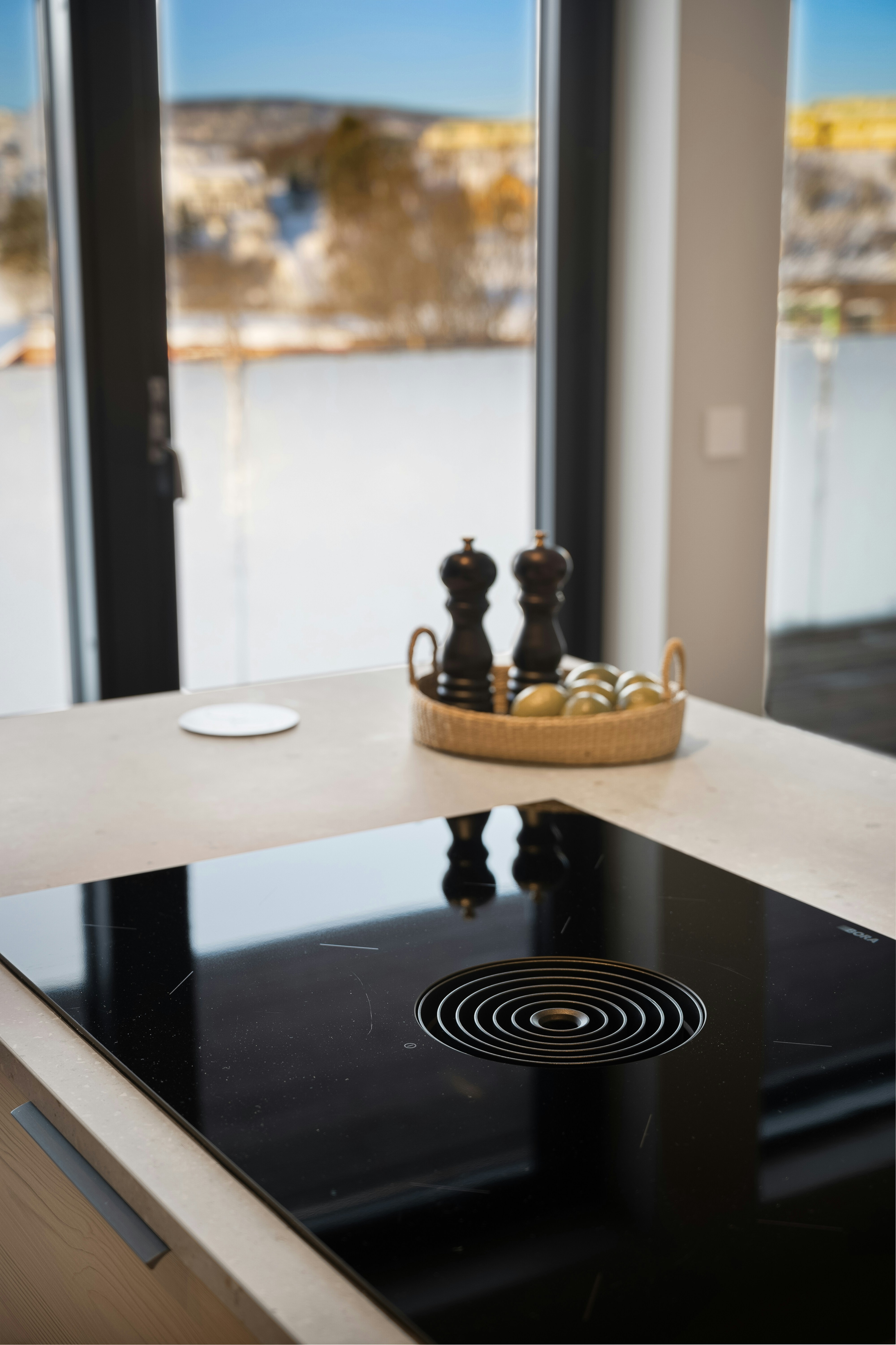 Built-in cooktop in a coastal kitchen with a view of the water in Pacifica