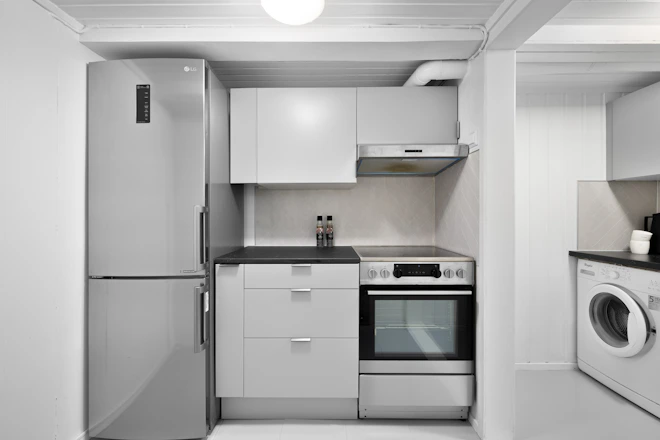 A small kitchen with a washer and dryer