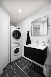 A bathroom with a washer and dryer in it