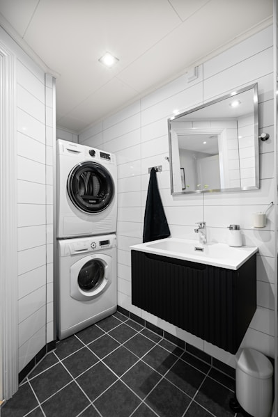 A bathroom with a washer and dryer in it