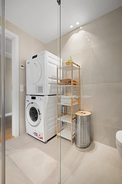 A washer and dryer sitting in a bathroom
