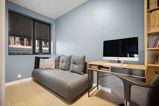 A living room with a couch and a desk