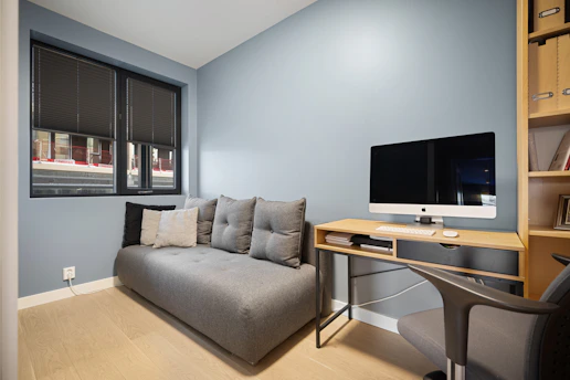 A living room with a couch and a desk