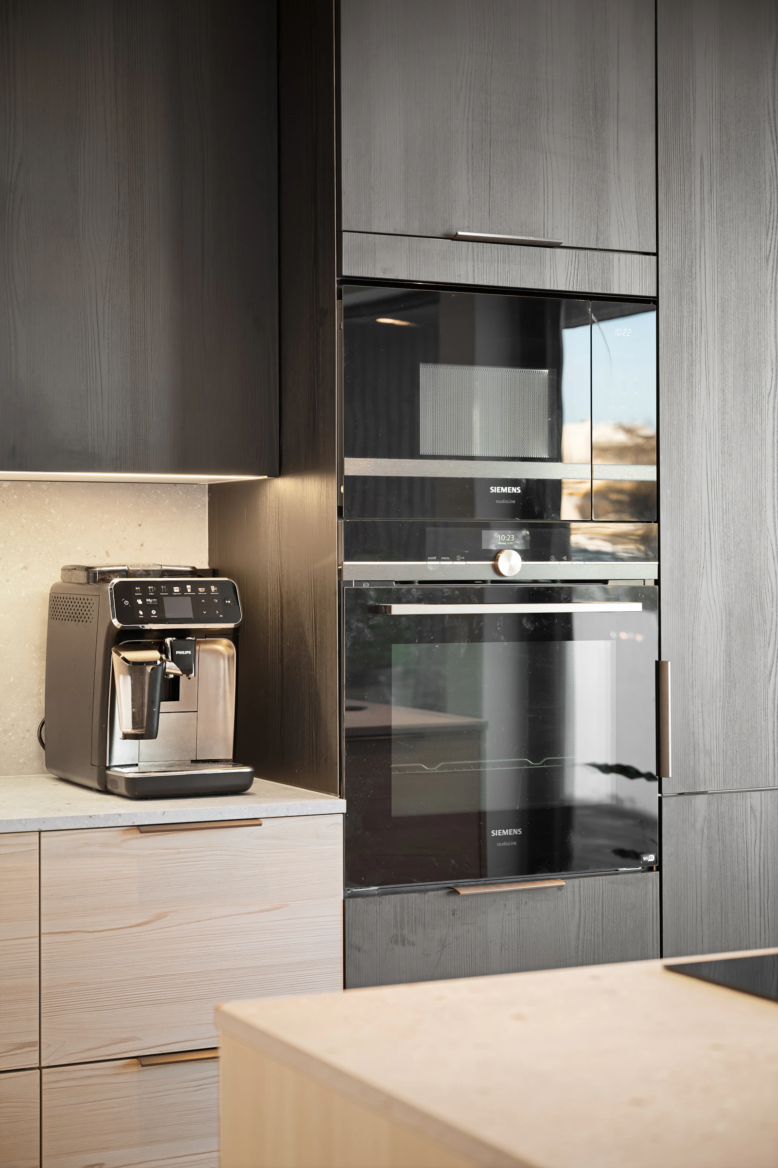Real modern kitchen with a countertop coffee machine and built-in oven
