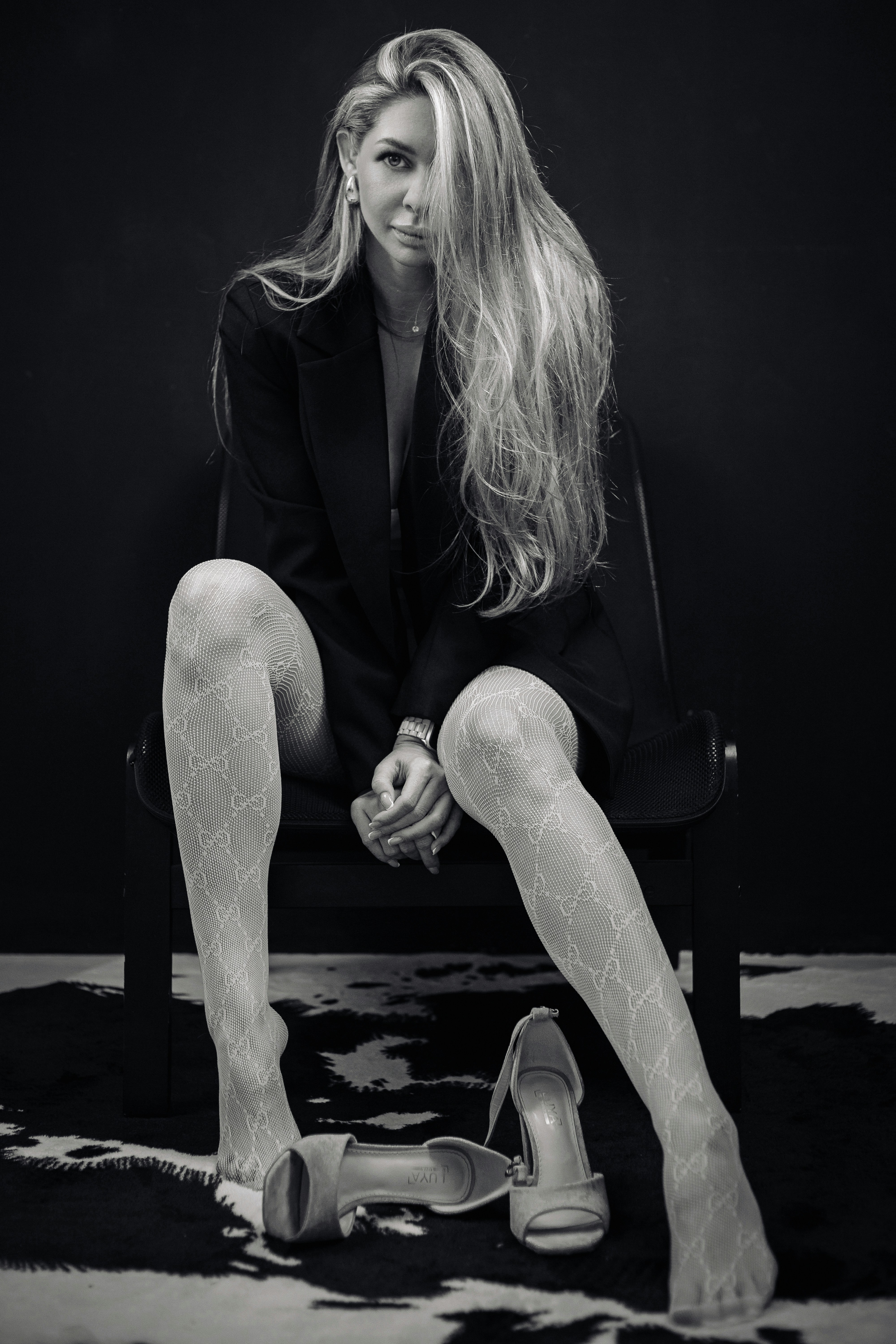 A woman sitting on a chair with her legs crossed