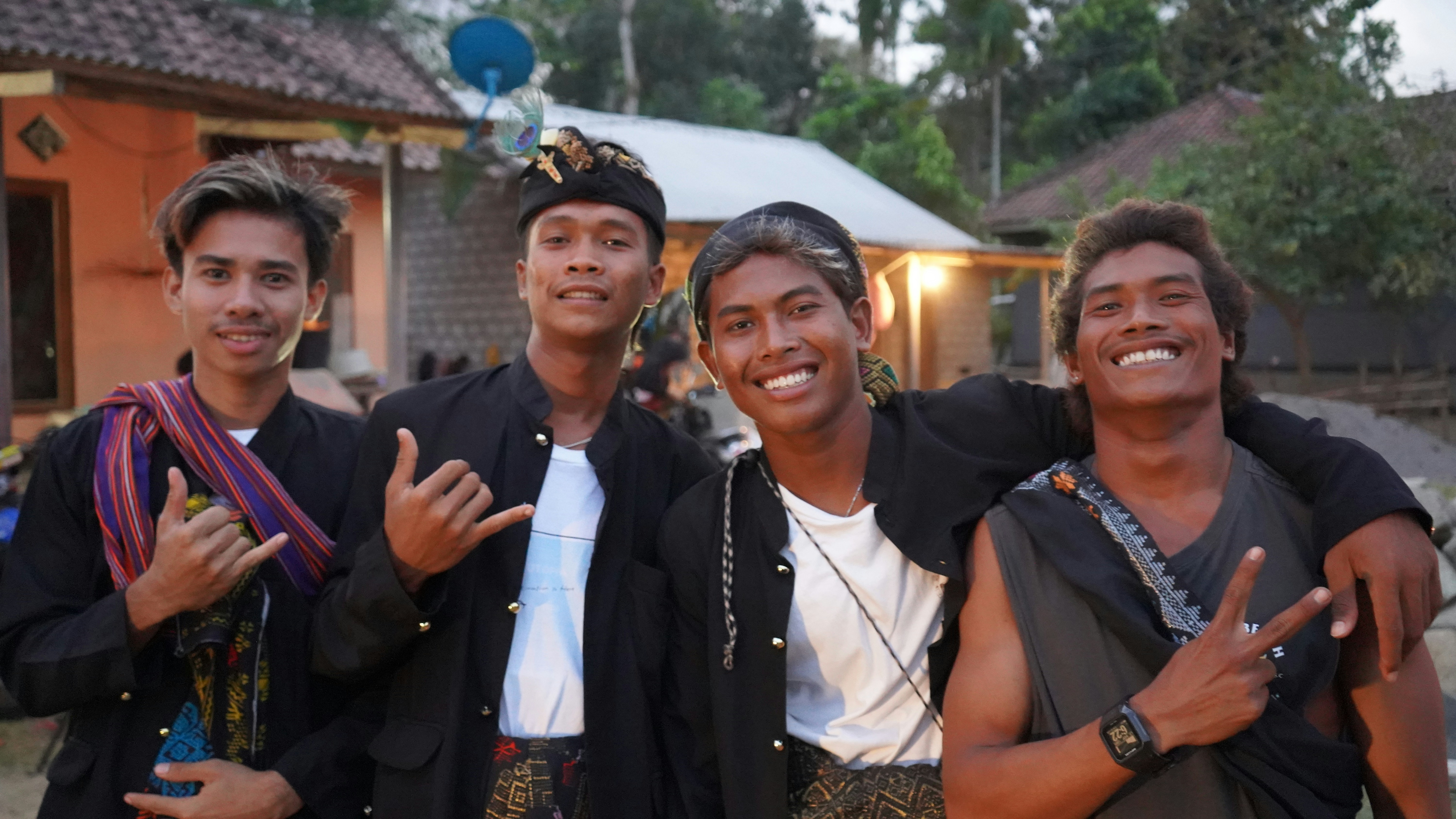 Young men in traditional Sasak attire enjoying a wedding celebration in Areguling village, reflecting the vibrant culture of Lombok