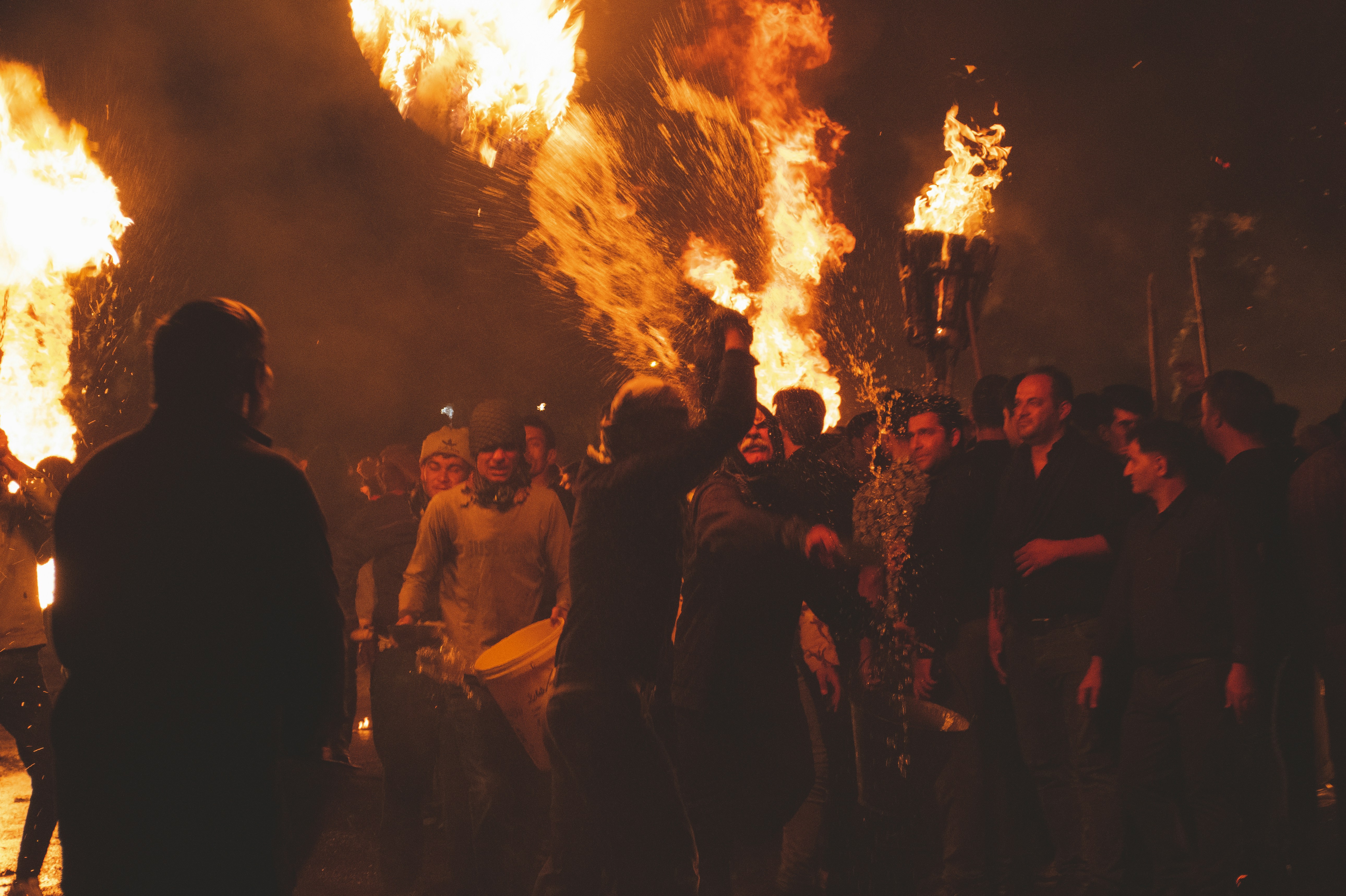 A large group of people standing around a fire