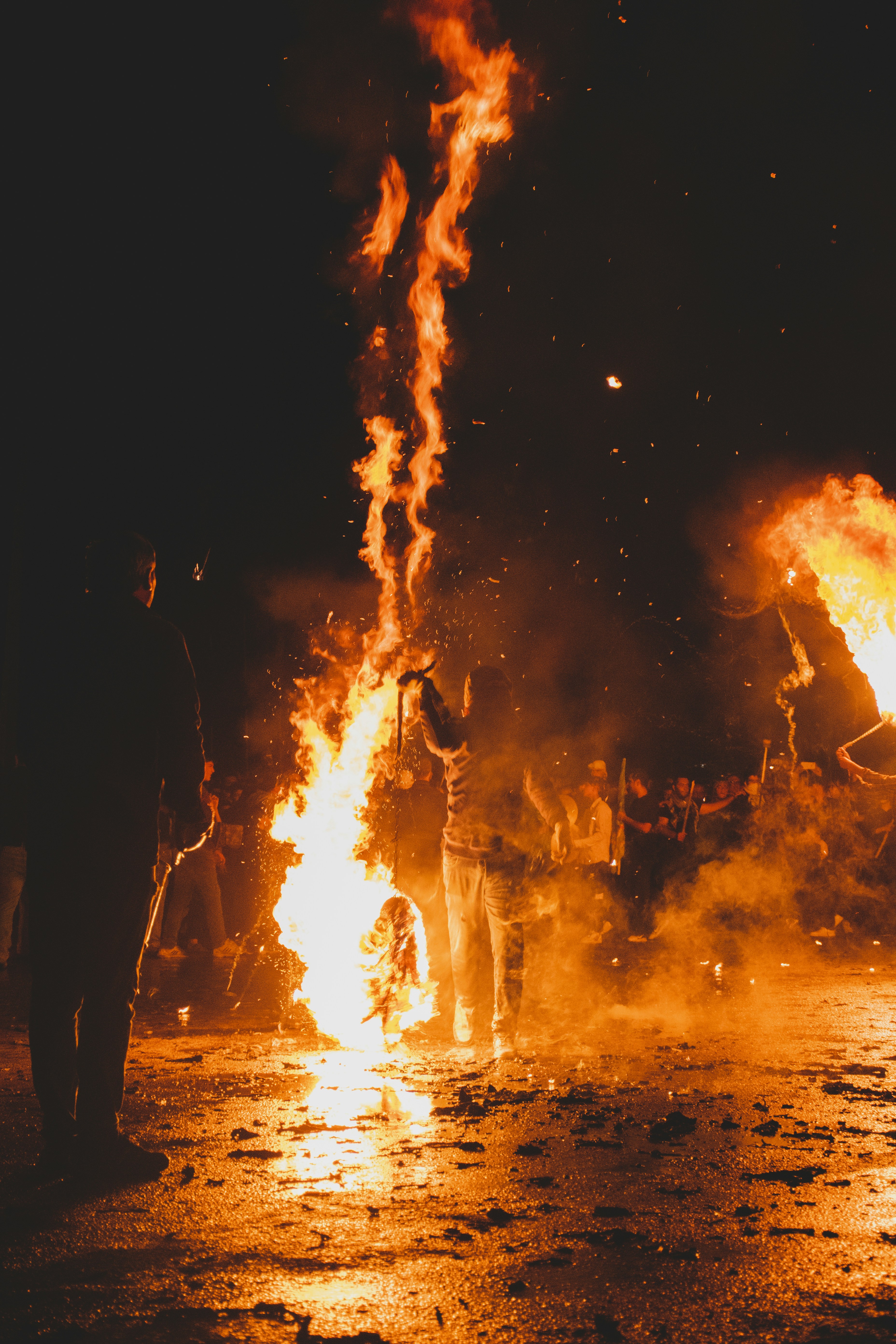 A group of people standing around a fire
