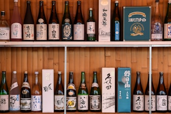 A shelf filled with lots of bottles of alcohol