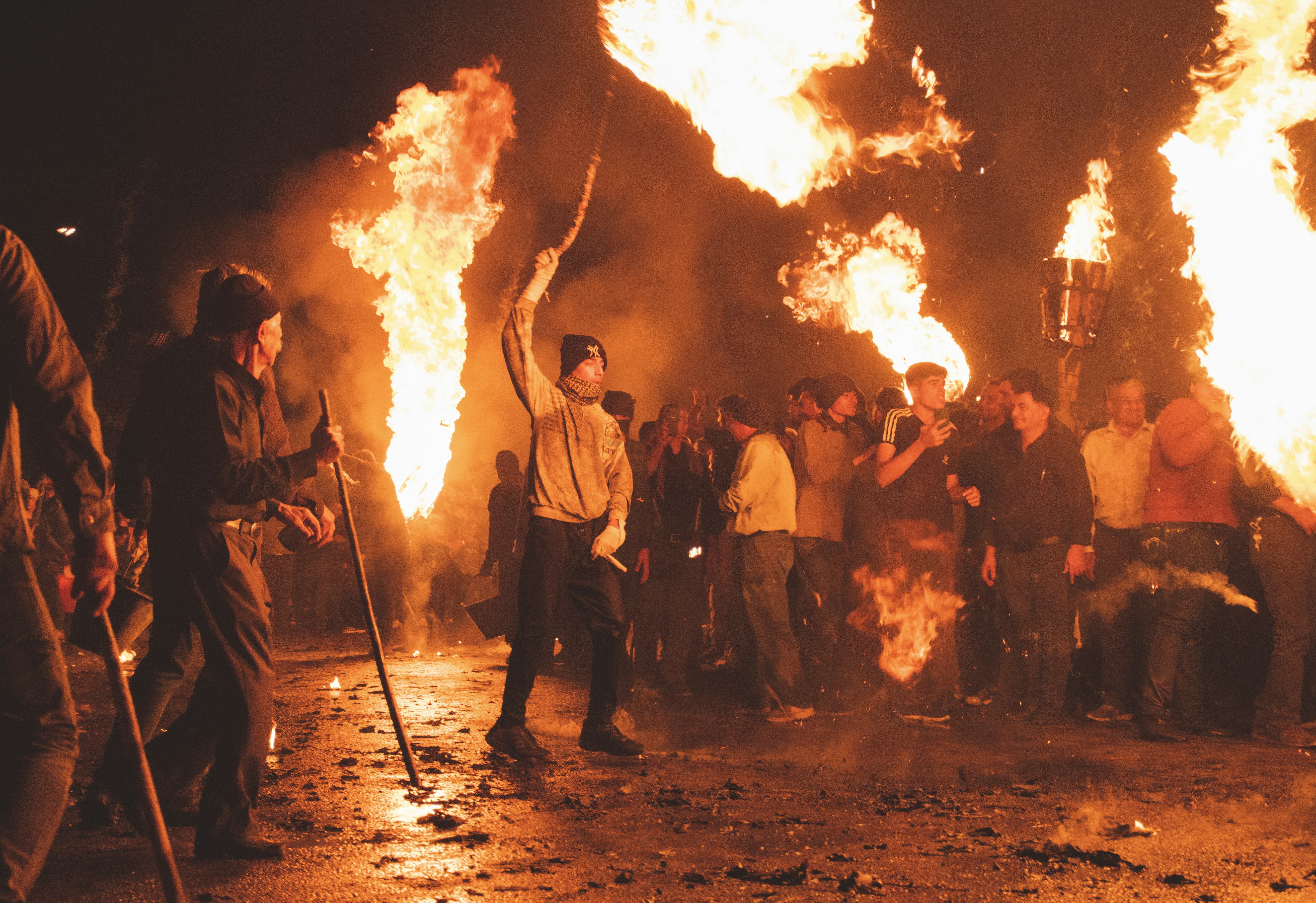 A group of people standing around a fire