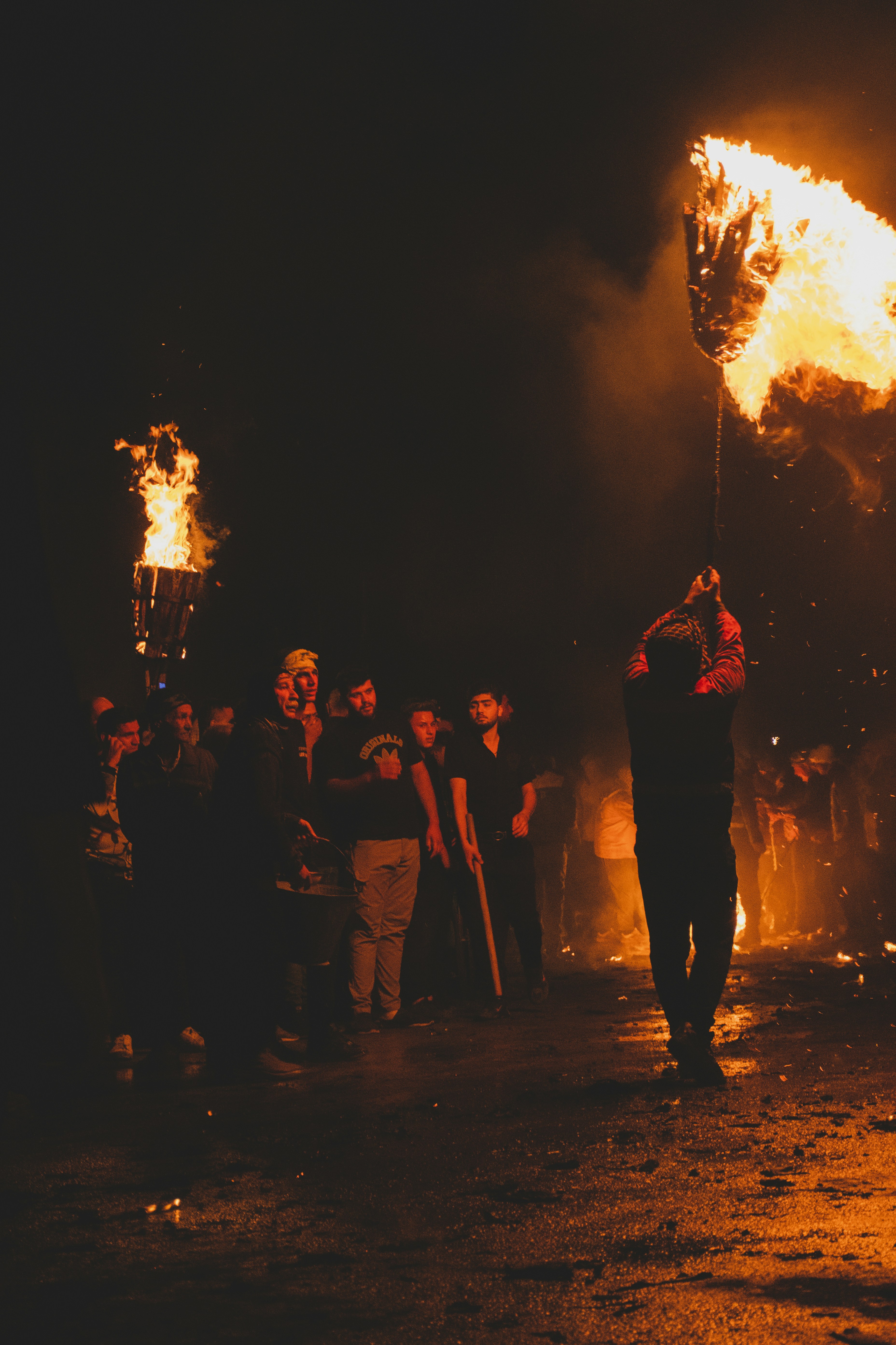 A group of people standing around a fire