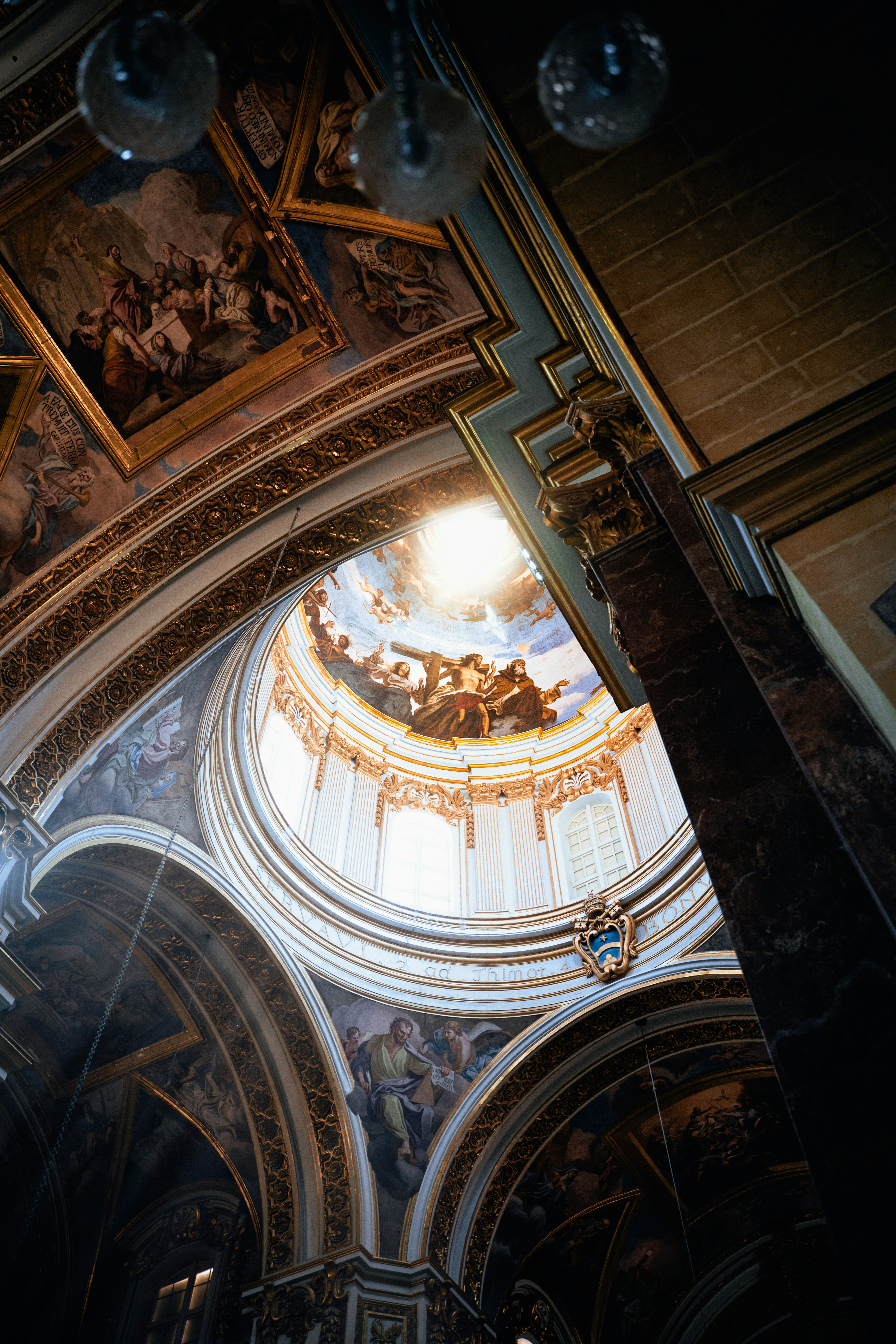 The ceiling of a church with a painting on it