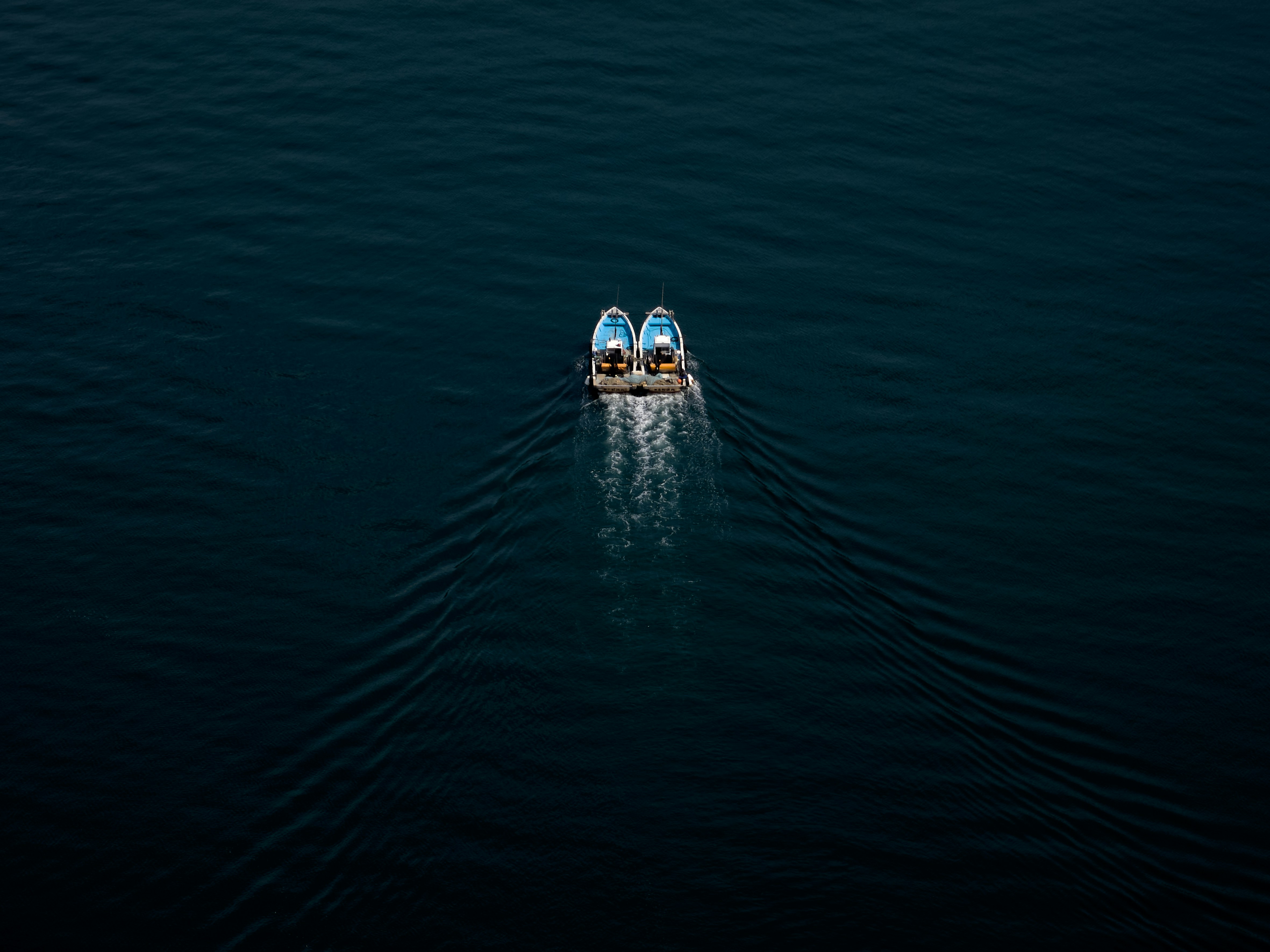 Two boats in a body of water with a sky background