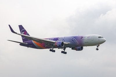 A large jetliner flying through a cloudy sky