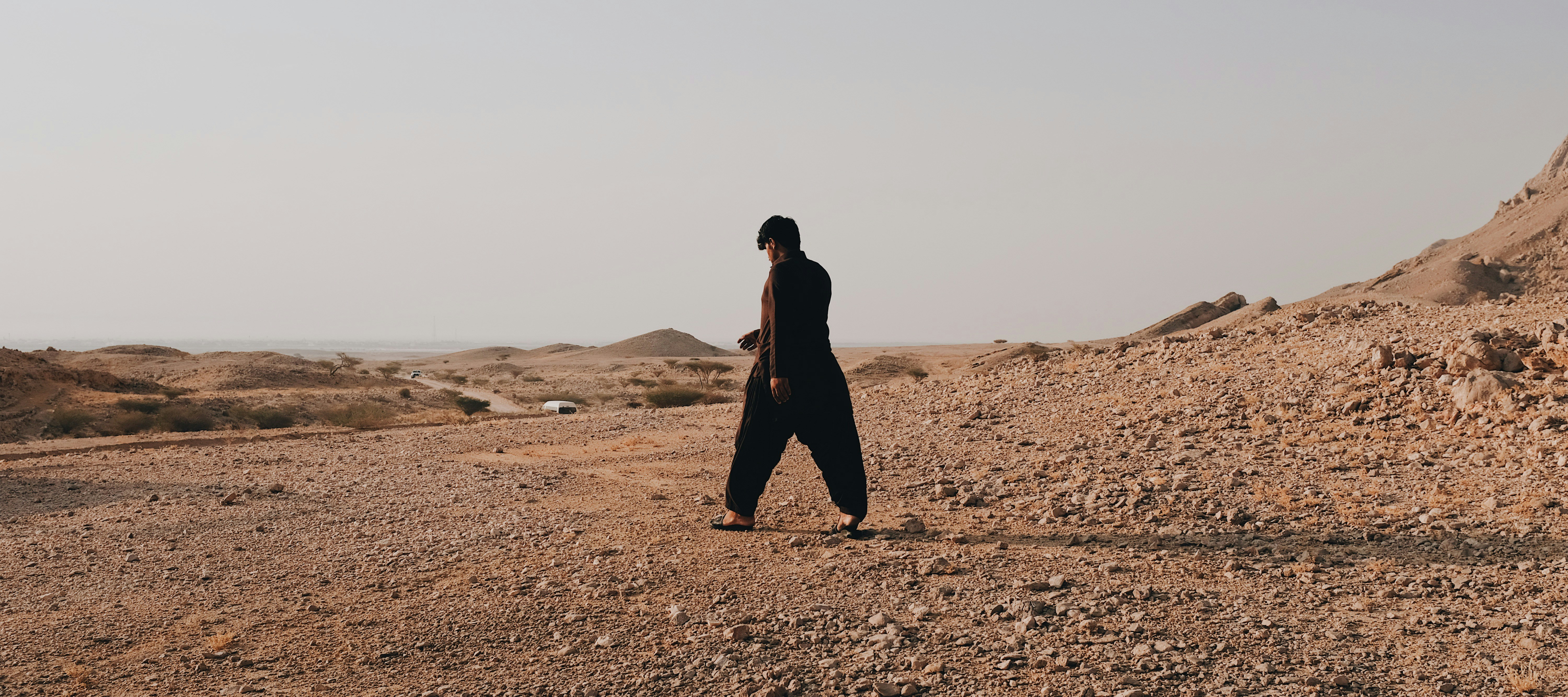 A man standing in the middle of a desert