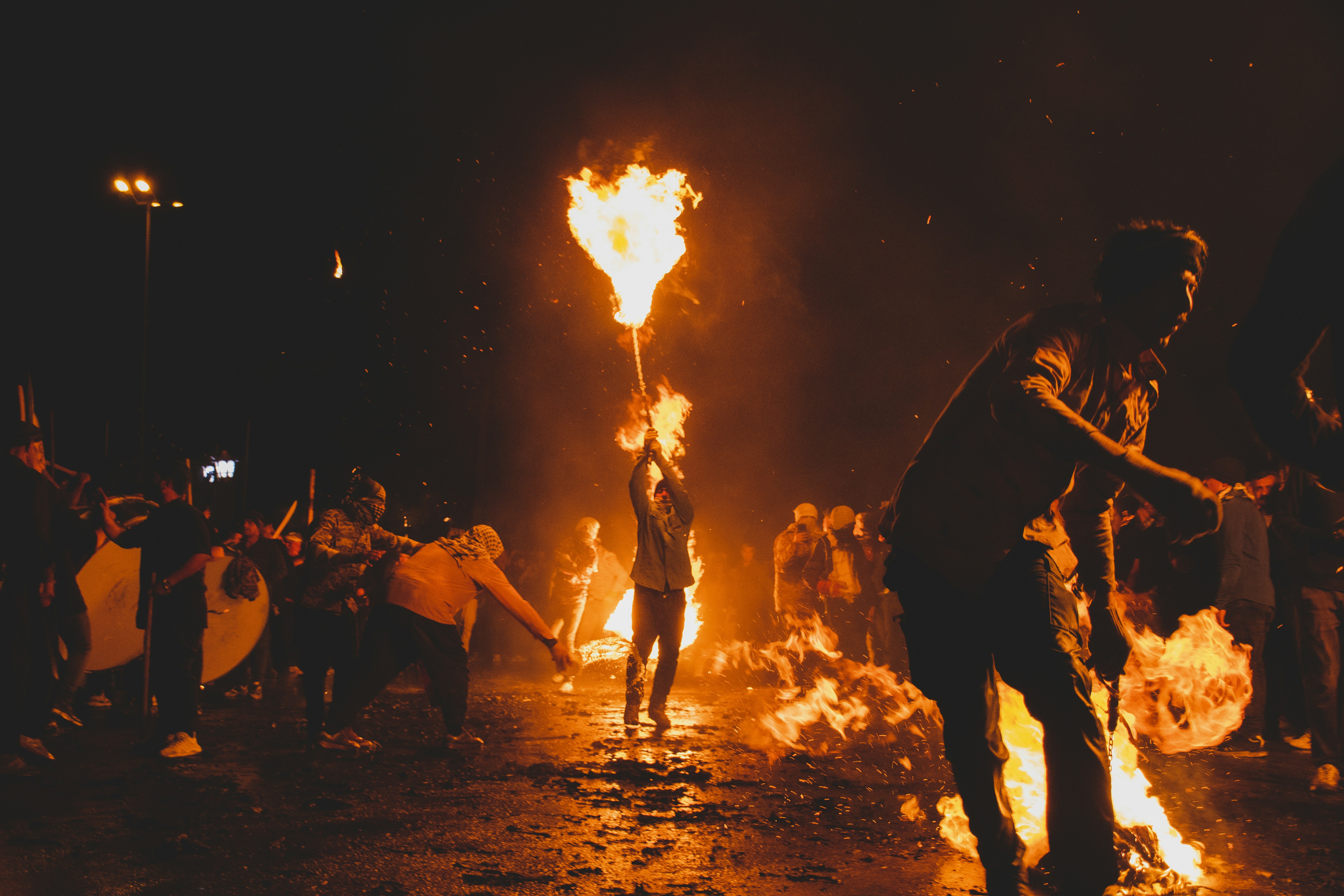 A group of people standing around a fire