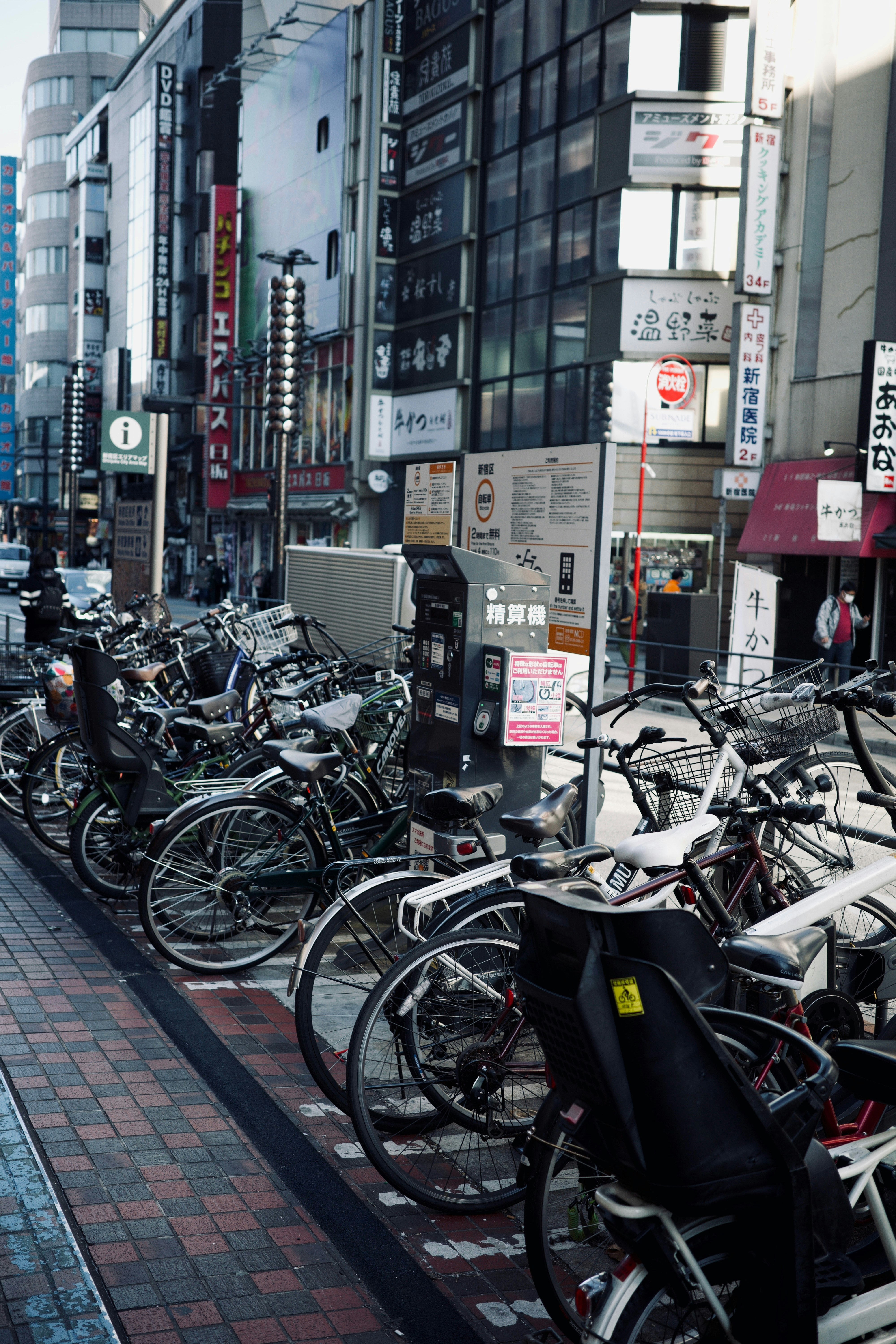 A row of bikes parked on the side of a street