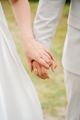 A close up of two people holding hands