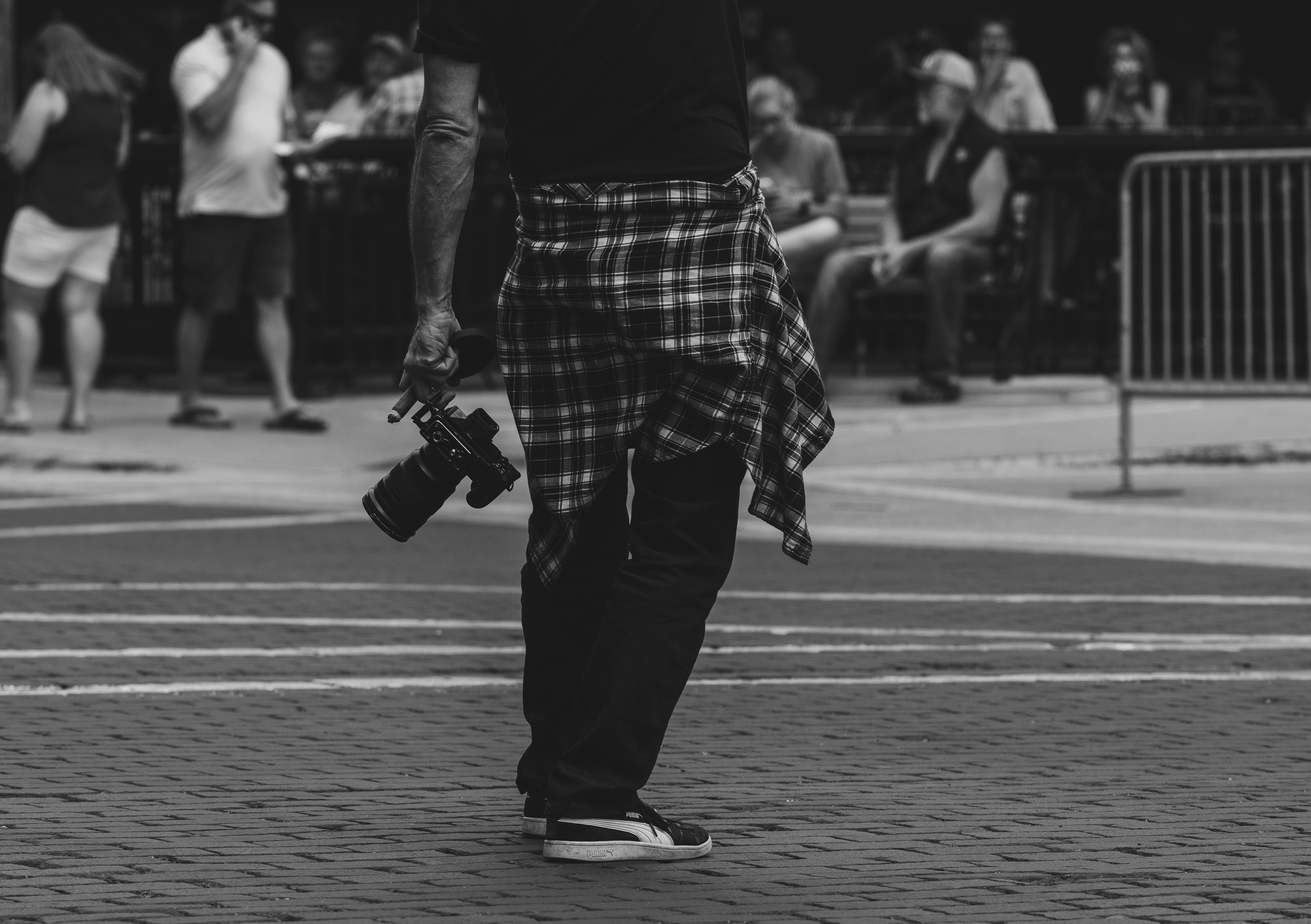 A man in a kilt walking down a street