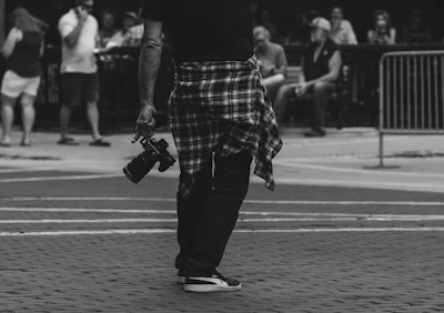 A man in a kilt walking down a street