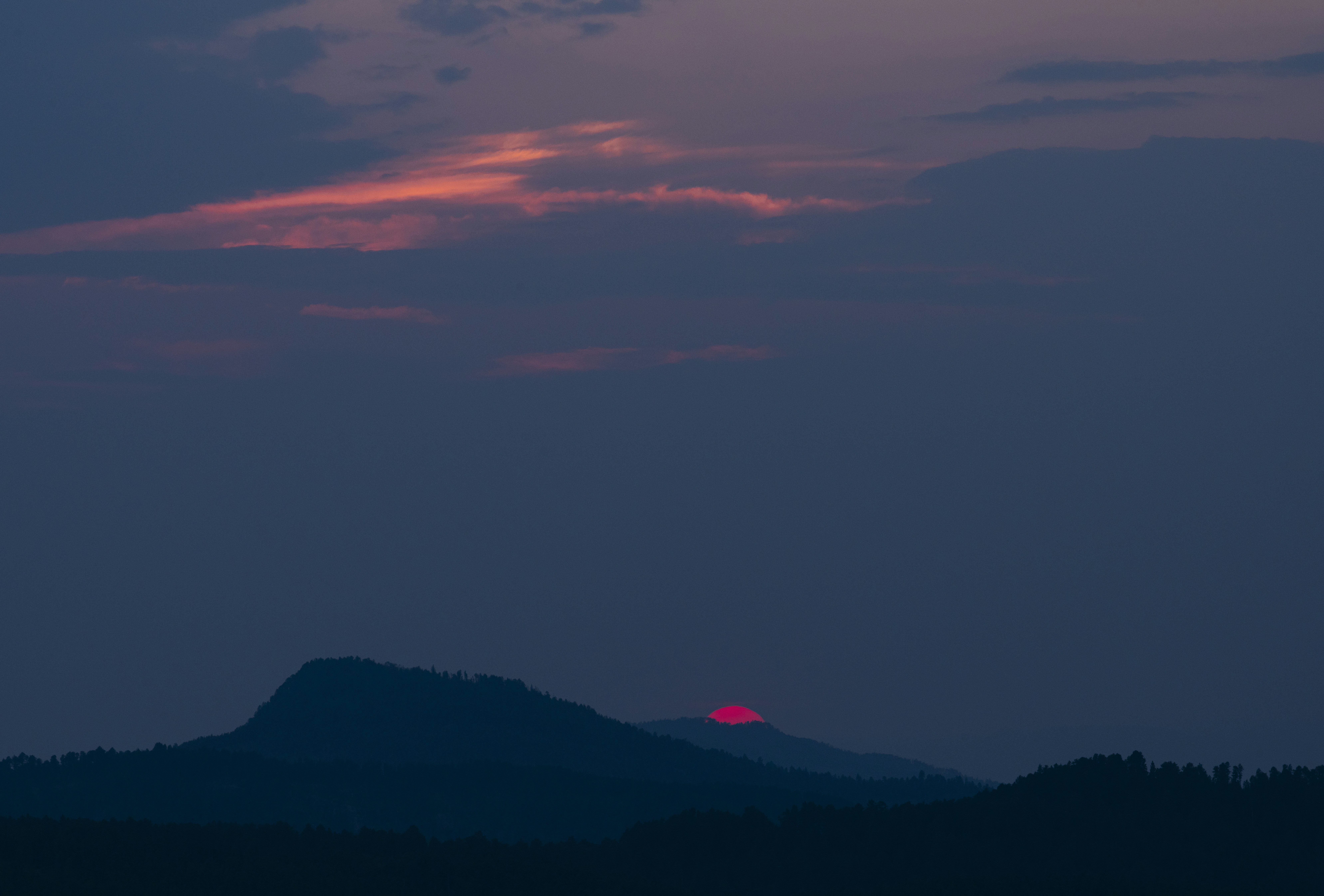 The sun is setting over a mountain range photo – Free Sunset Image on ...