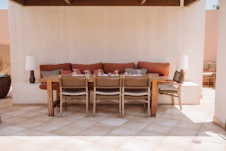 A patio with a table and chairs and a couch
