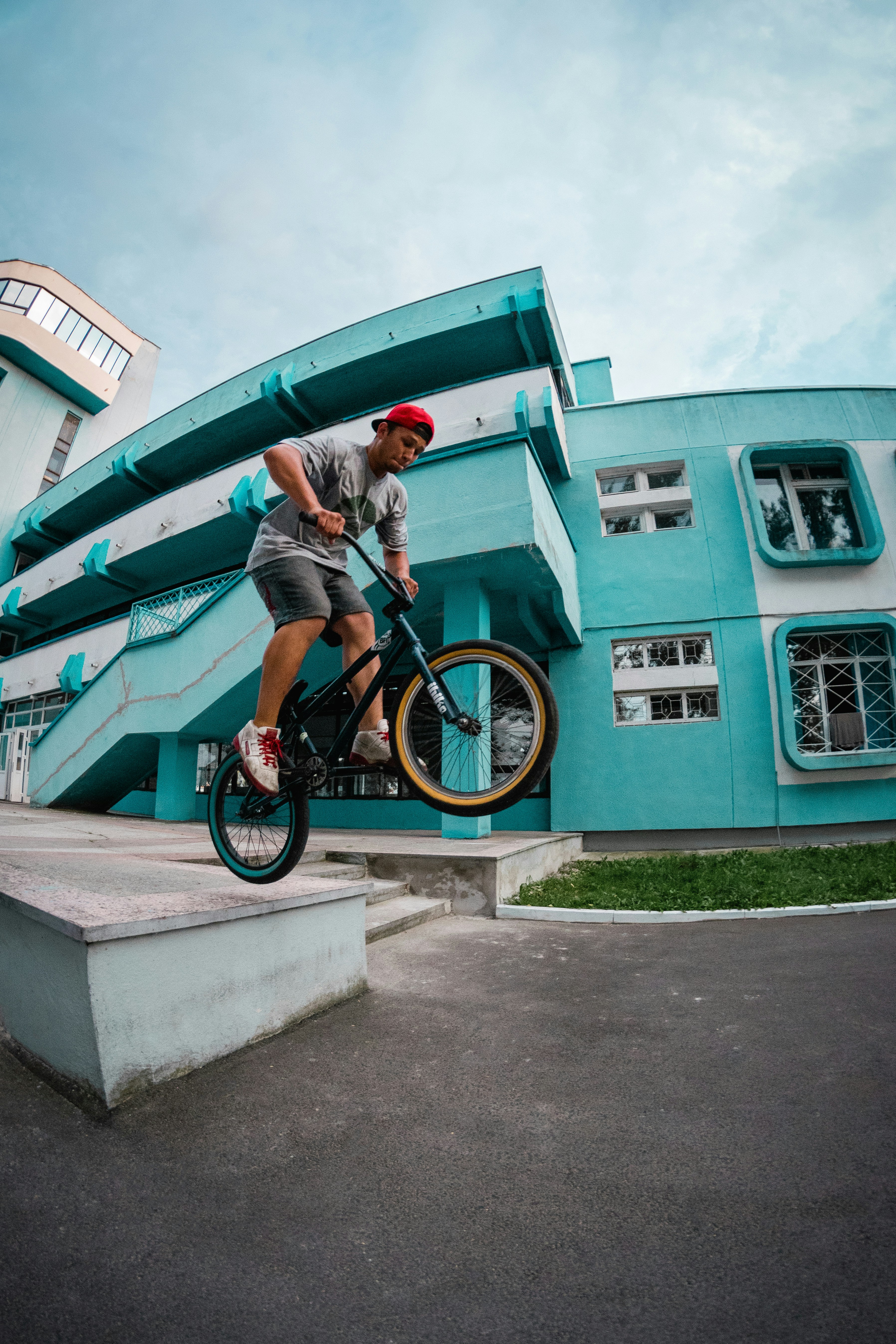 A man riding a bike up the side of a ramp