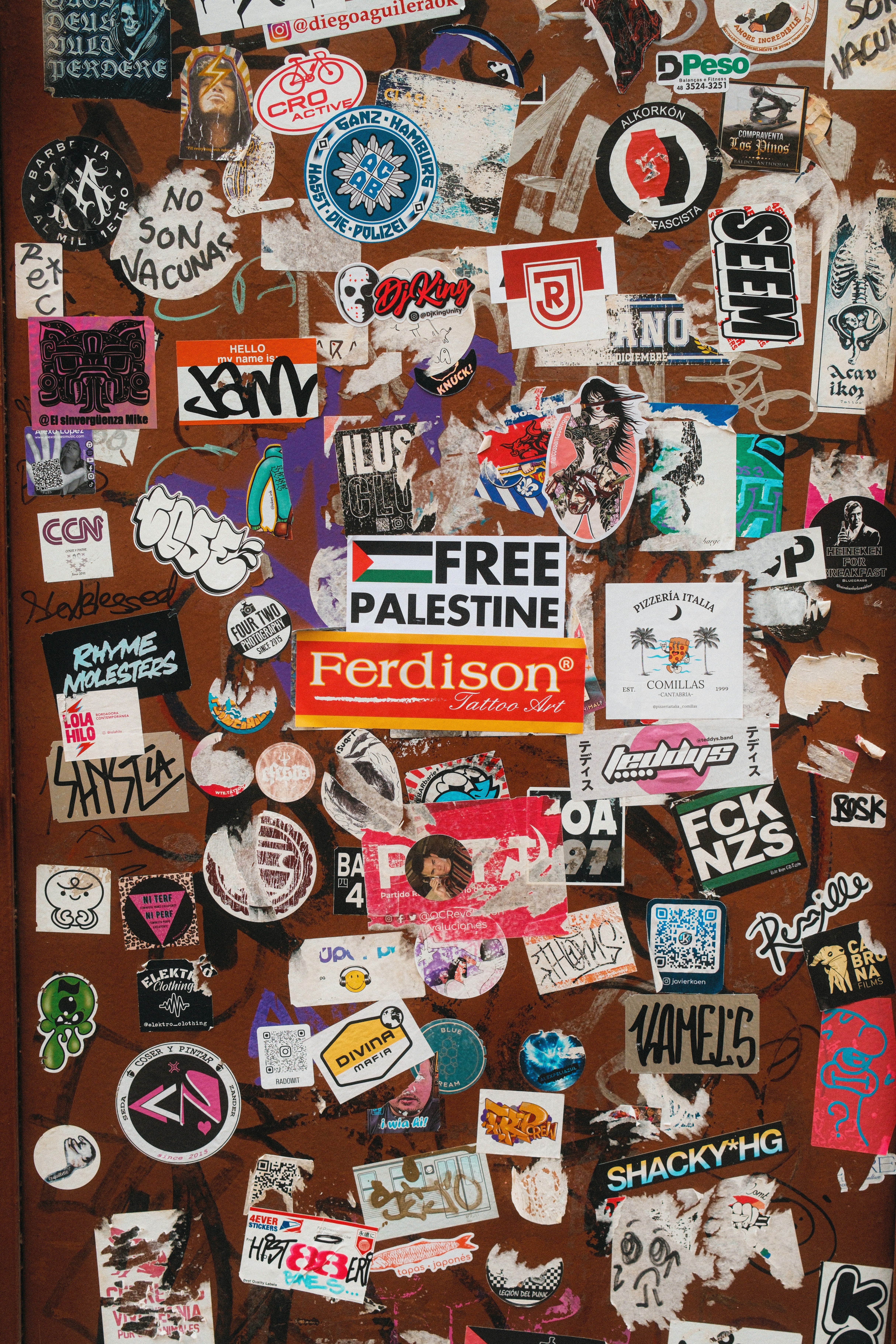 A door covered in lots of stickers and magnets