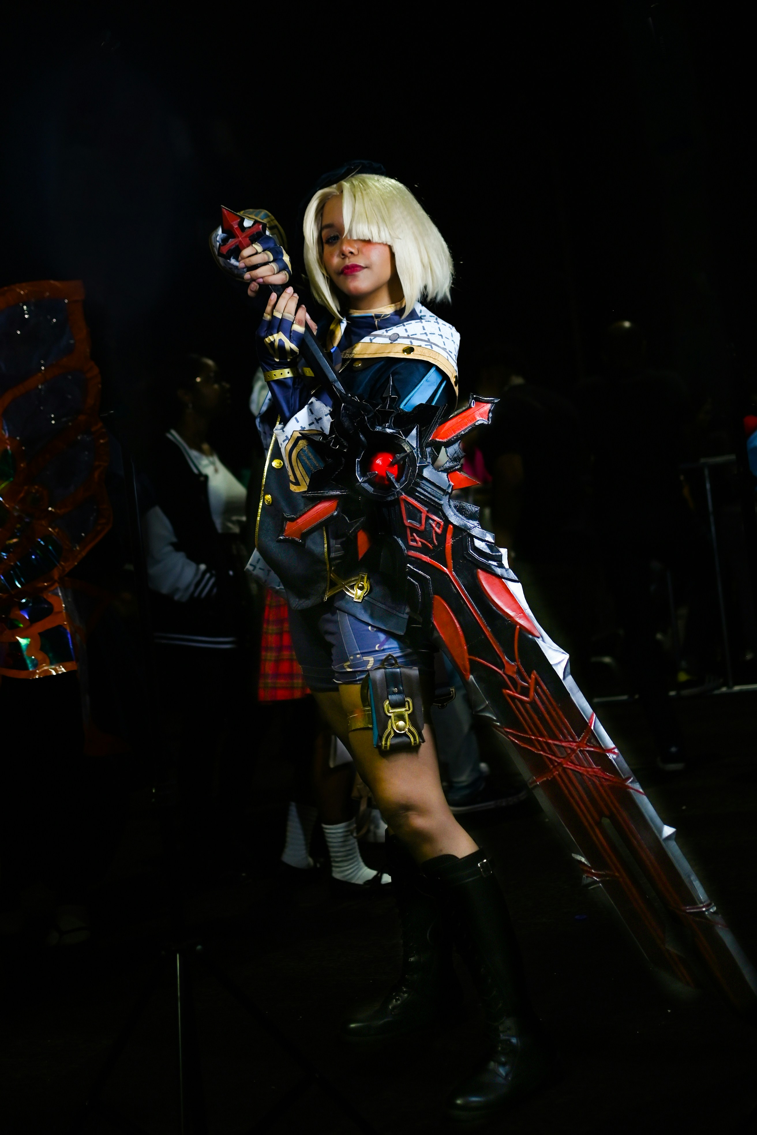 A woman in a cosplay holding a sword