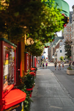 A street lined with shops and people walking down it