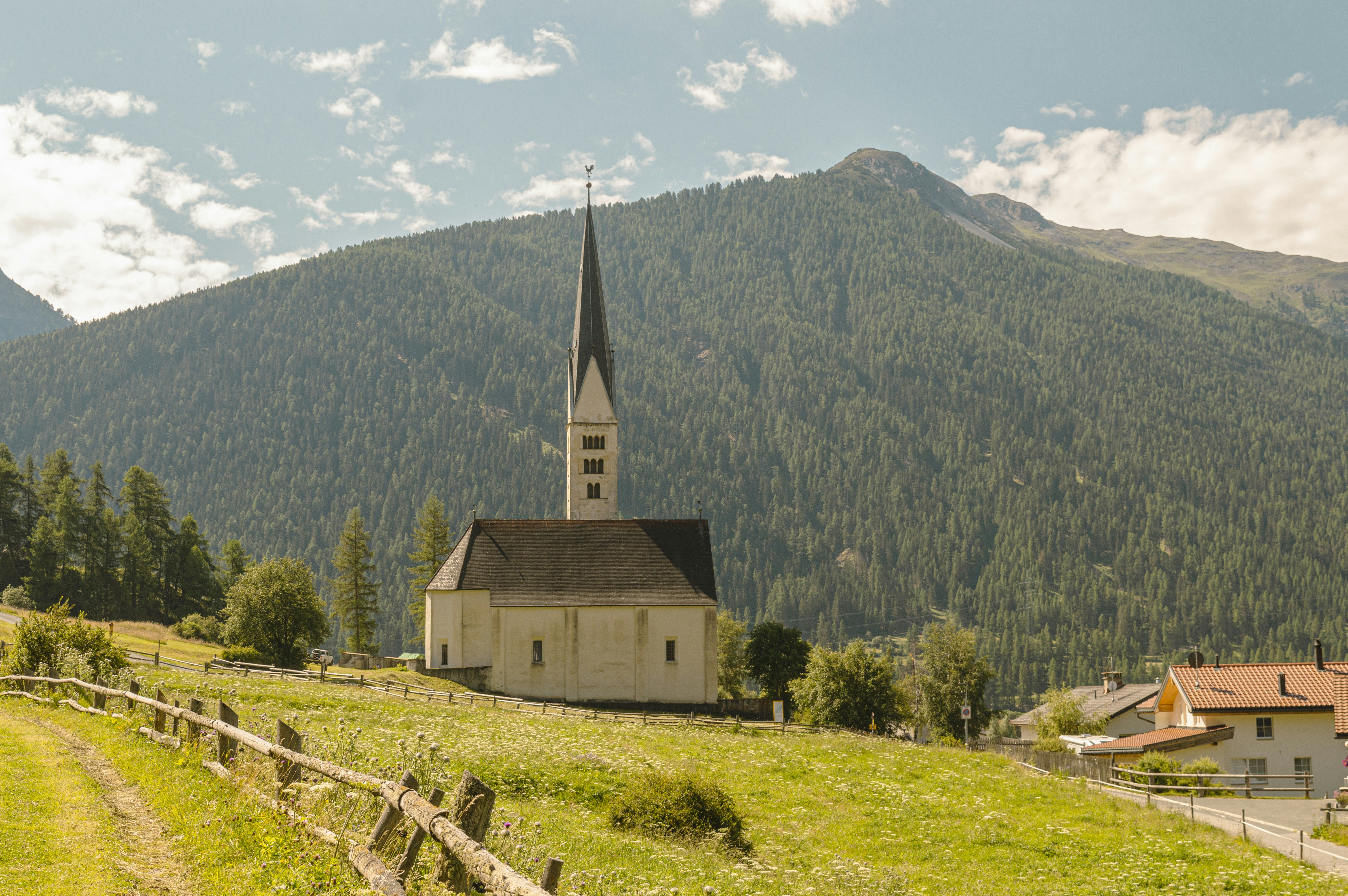 A church on a hill with a mountain in the background