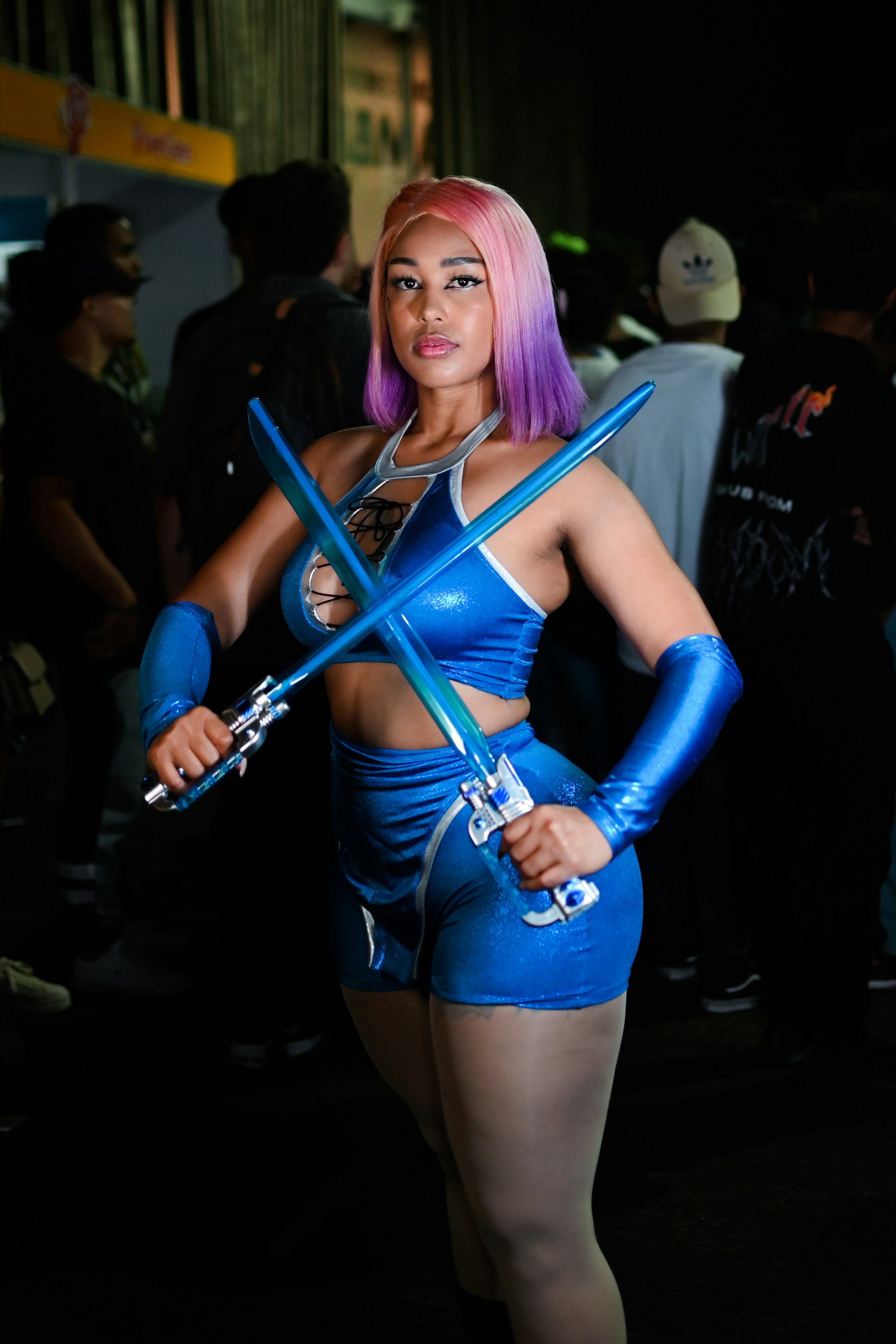 A woman in a blue outfit holding two swords