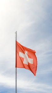 A red and white flag flying in the sky