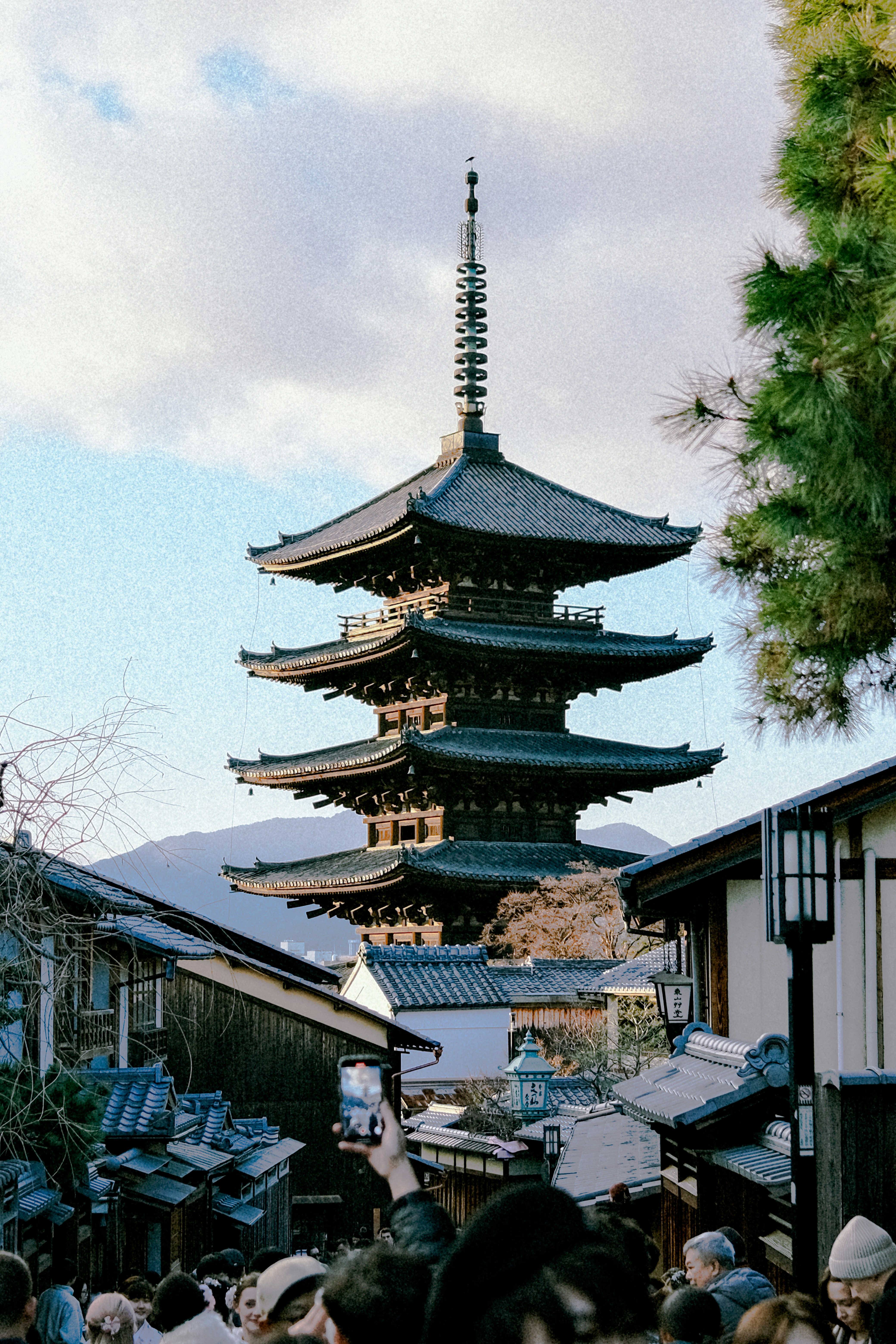 A crowd of people standing around a tall building