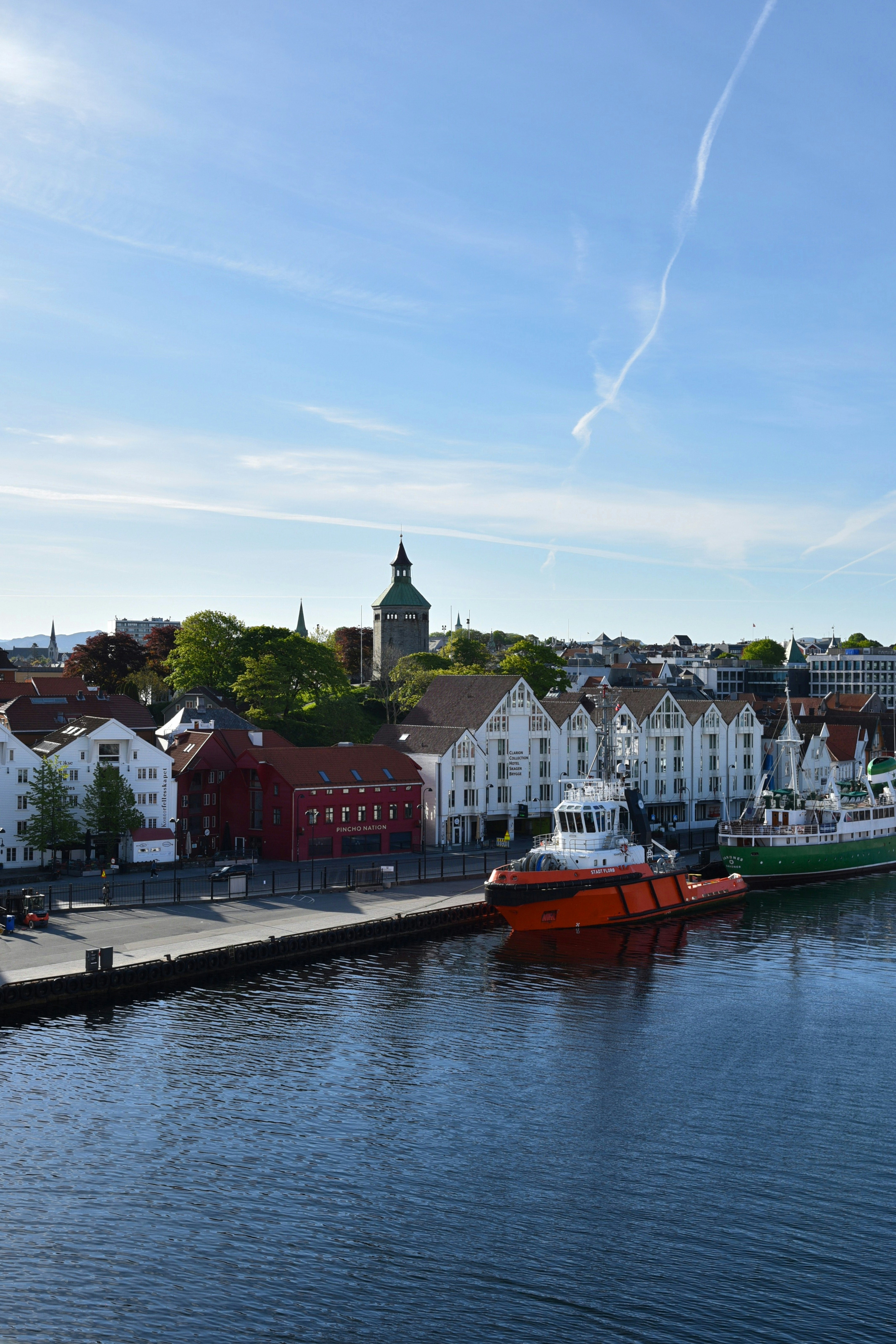 A harbor filled with lots of boats next to tall buildings