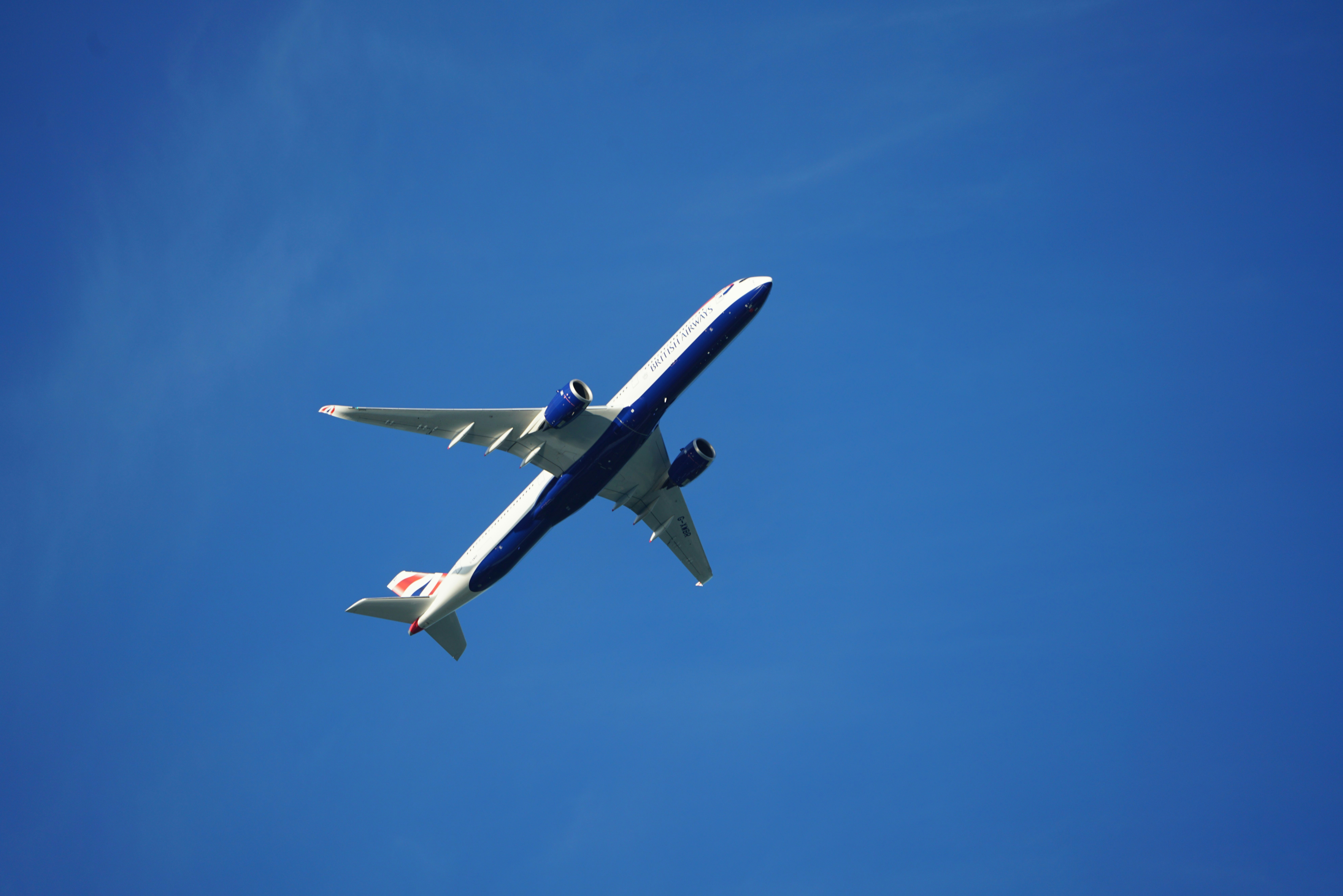A large jetliner flying through a blue sky