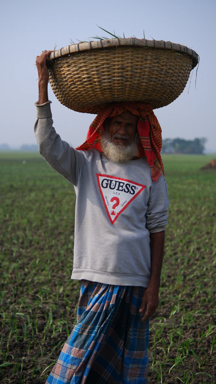Bangladeshi farmer carrying harvest basket